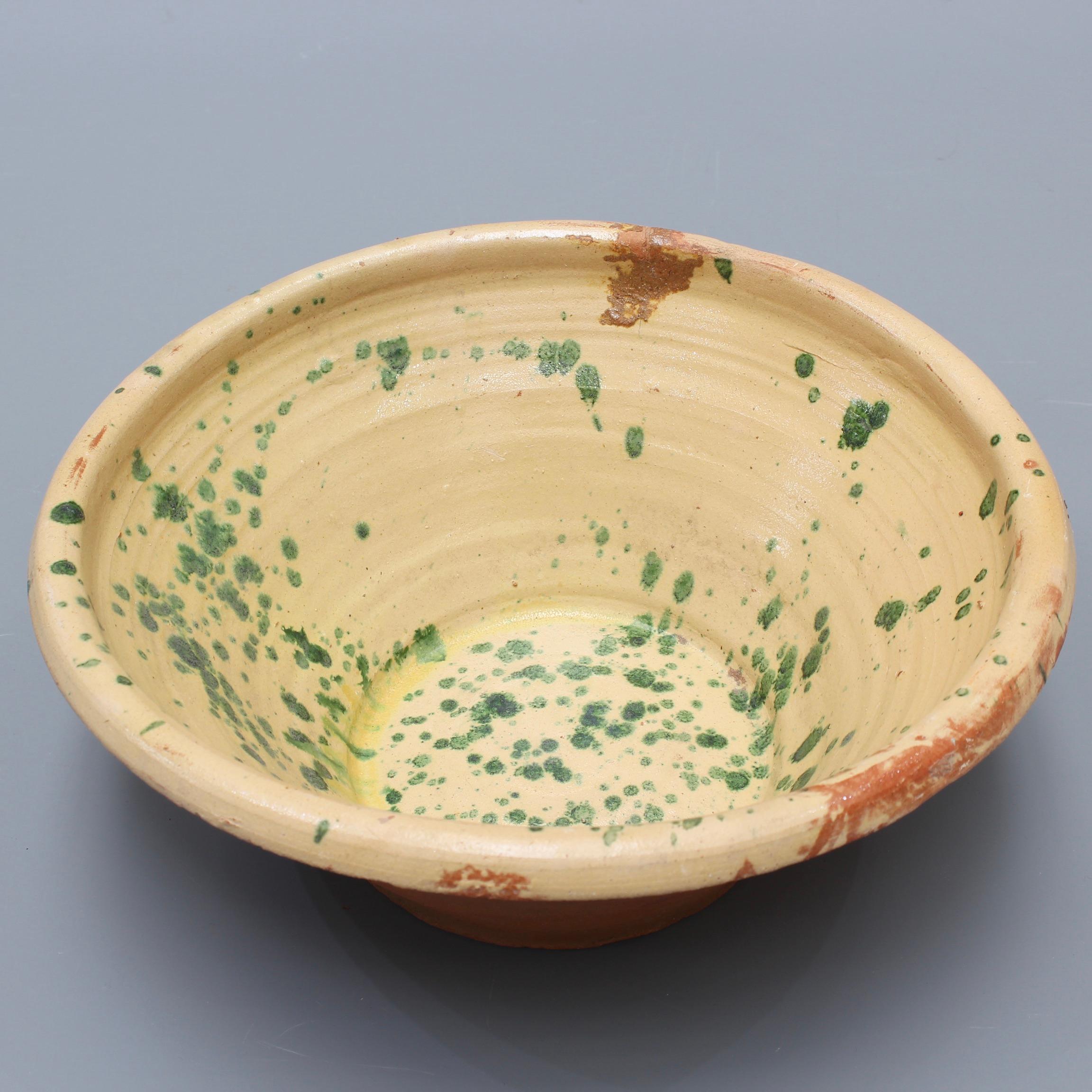 Small early 20th century Italian passata bowl from the South of Italy, probably Puglia or Calabria. Created to make tomato passata, these homespun terracotta bowls are made of rustic earthenware on the exterior and a charming, glazed interior of