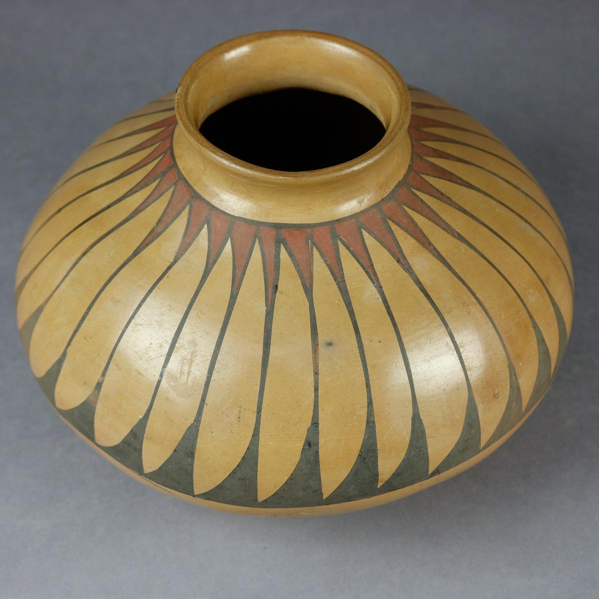 An antique Southwest Native American Indian hand thrown pottery vase from the Acoma Pueblo offers bulbous form with polychromed repeating stylized feather band hand painted with yucca brush, circa 1900

Measures: 7