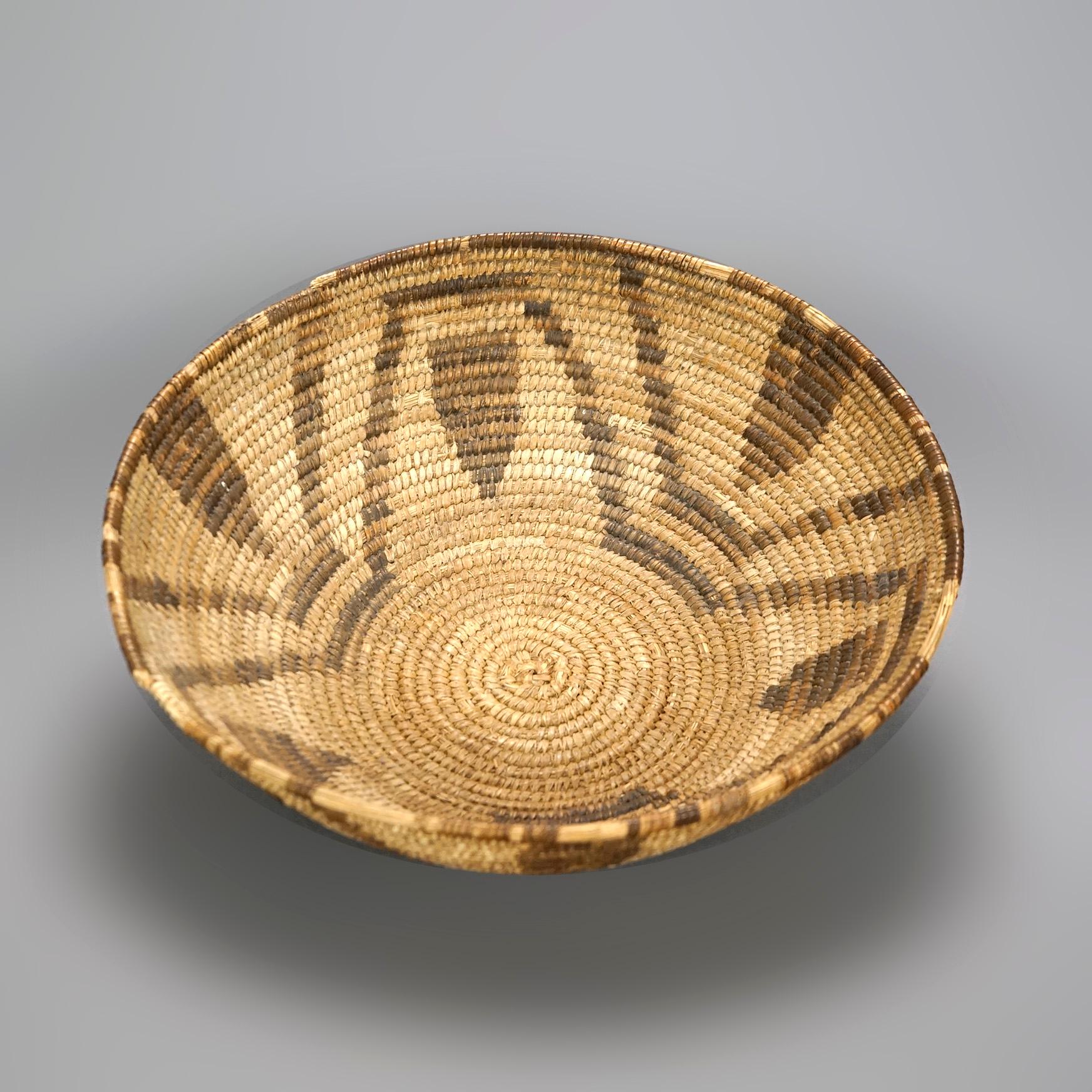 An antique Southwestern American Indian basket offers hand woven construction with flared sides and repeating geometric design, c1920

Measures- 4.25''H x 12.75''W x 12.5''D