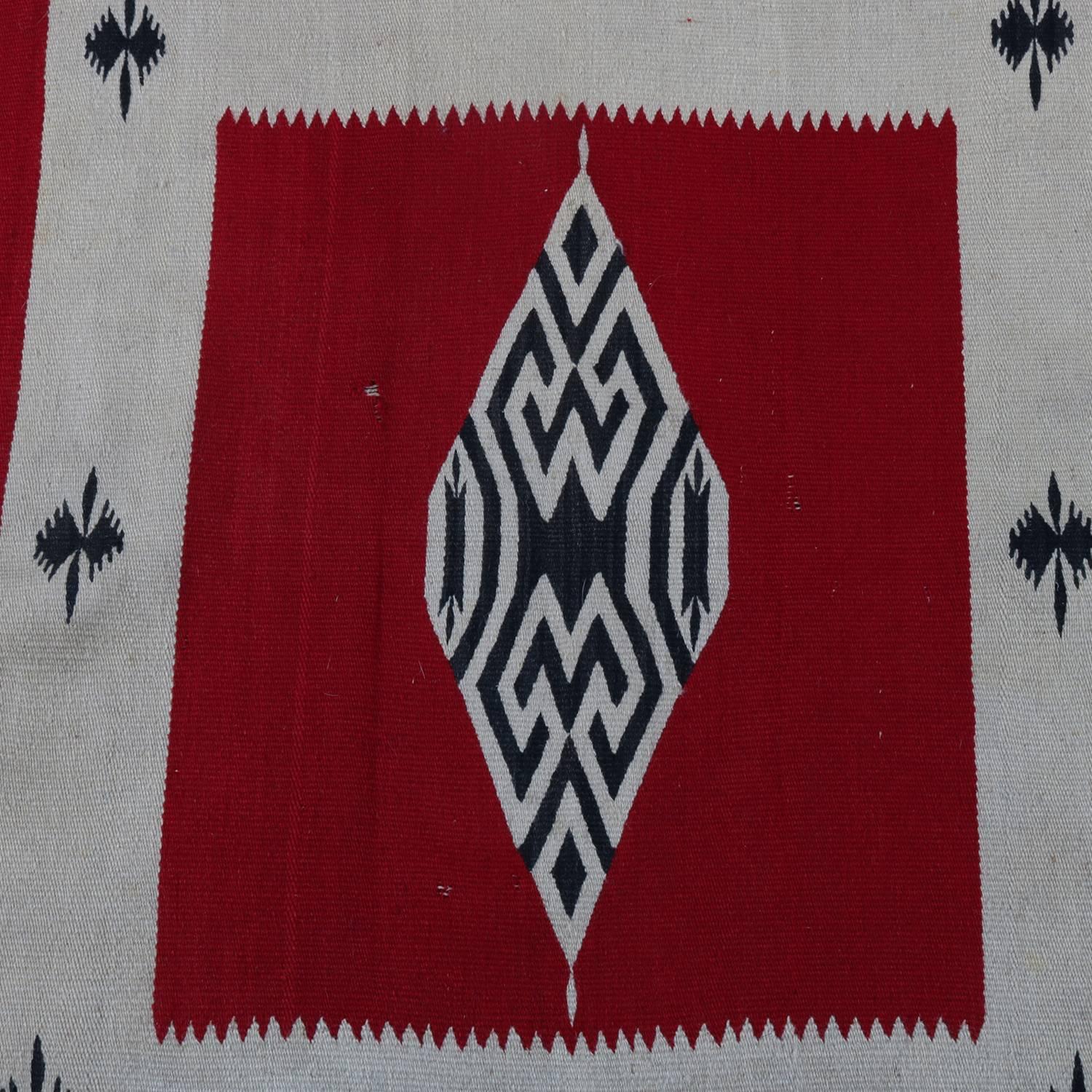 Antique Southwestern American Indian Serape style Navajo mat features wool construction with central diamond with flanking stripes, dominant colors include red, black and ivory white, circa 1920

***DELIVERY NOTICE – Due to COVID-19 we are employing