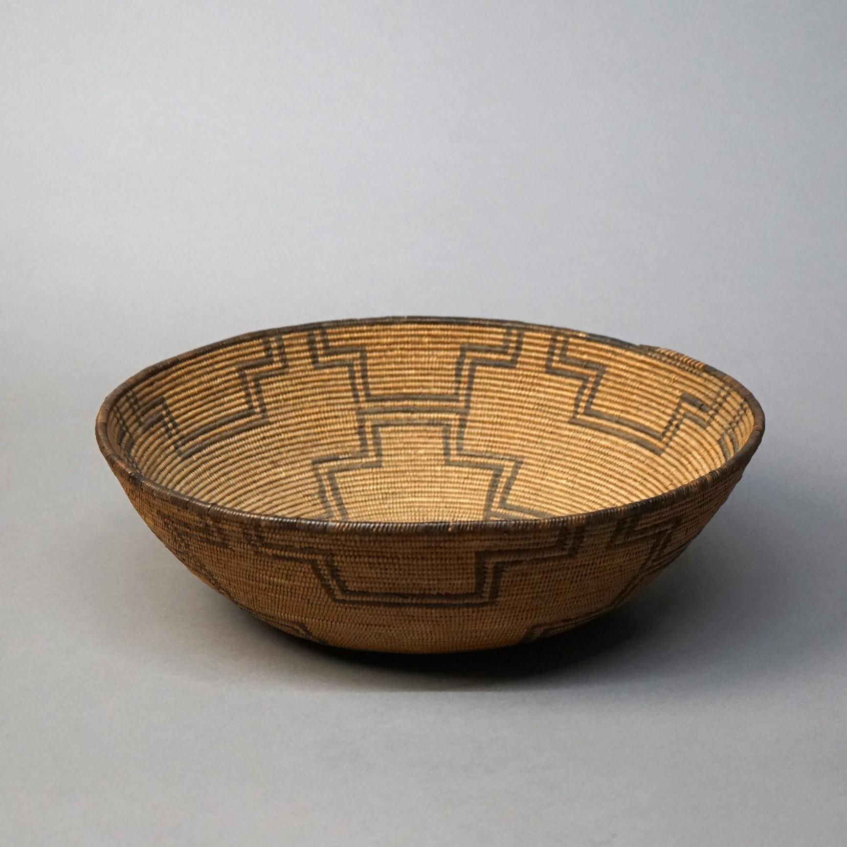 An antique and large Southwestern American Indian Navajo center basket offers woven reed construction with geometric design, c1920

Measures - 4.5