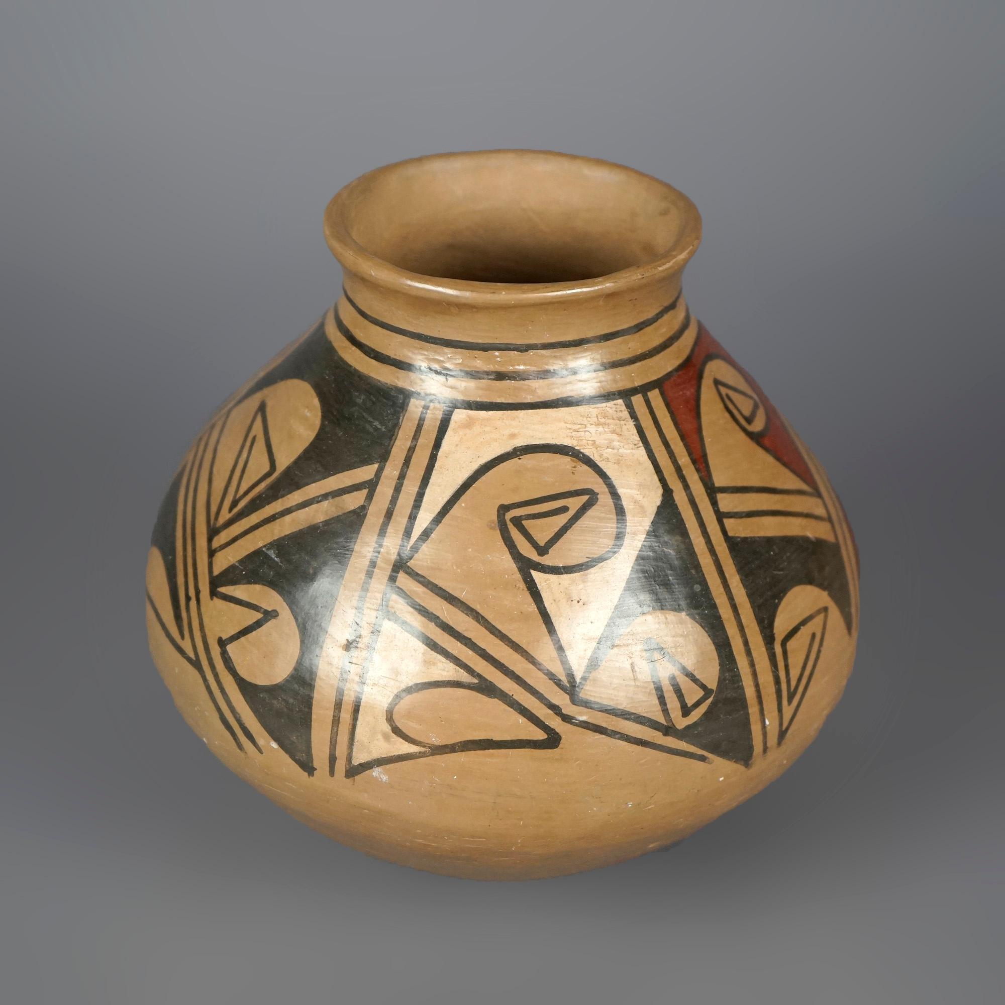 An antique Southwestern Navajo pottery vase offers earthenware construction with stylized geometric elements, unsigned, c1930

Measures- 7.25'' H x 7.5'' W x 7.5'' D.