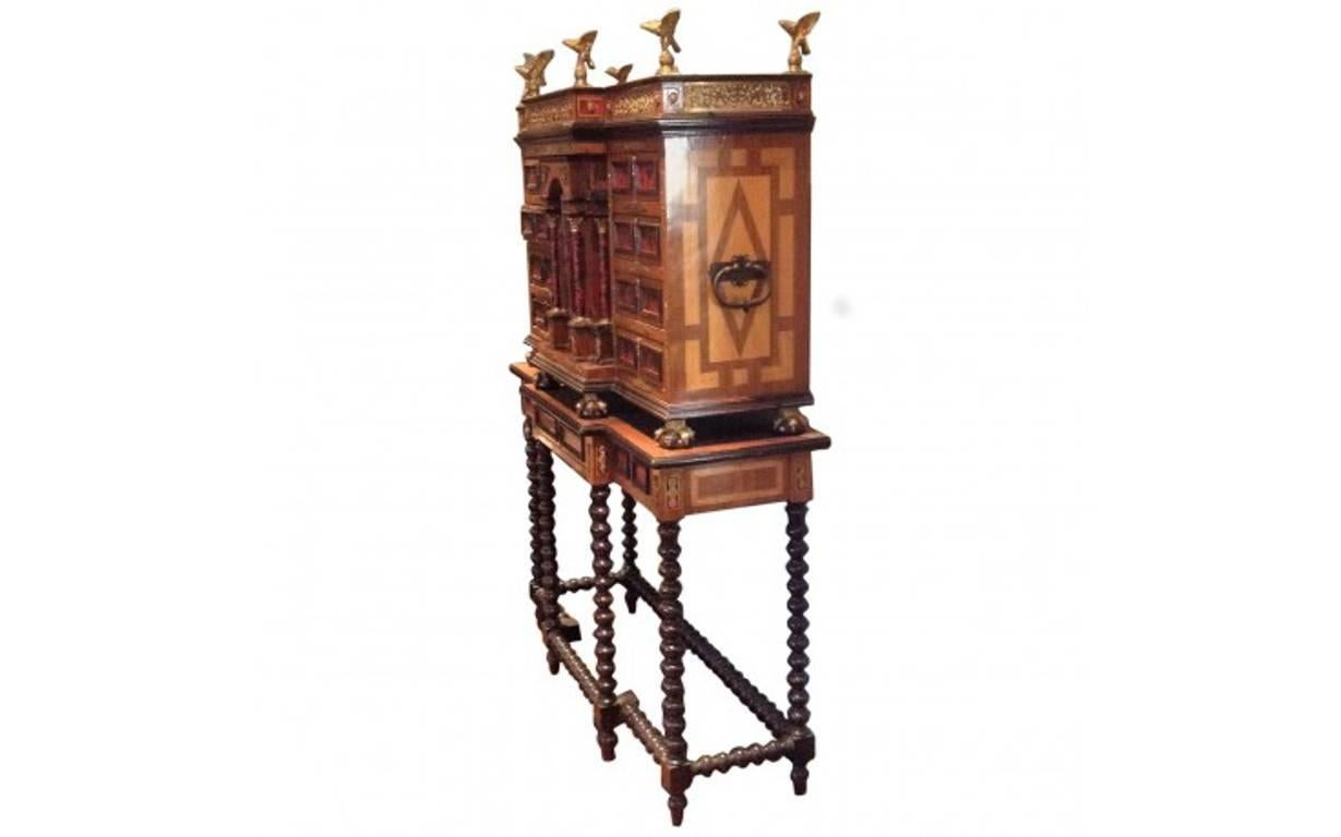 A collectible piece from bygone days, featuring the finest craftsmanship, materials, and design elements of its given era. Bold and sophisticated, this eye-catching cabinet stand is composed of walnut, oak, and satinwood, and can come apart to be