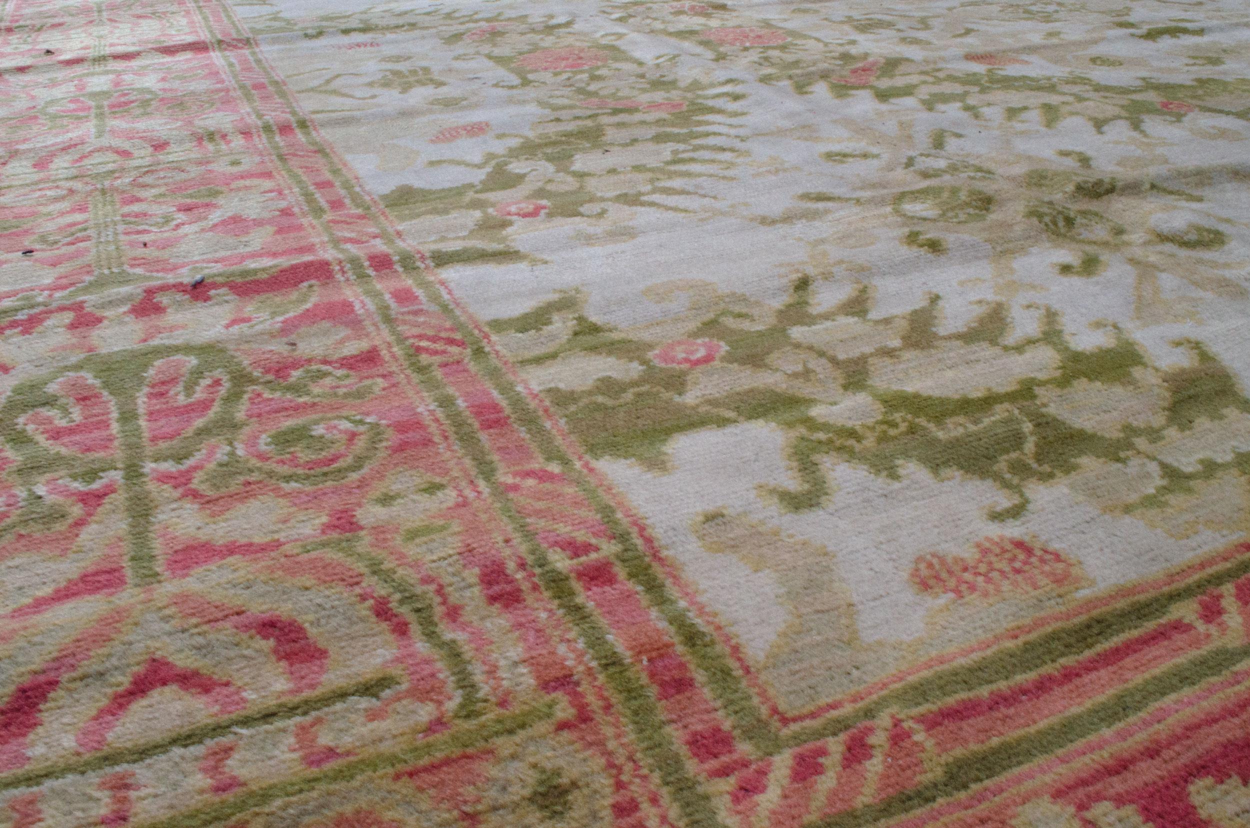This exquisite early-twentieth-century carpet was produced in Alcaraz, Spain. This carpet is an excellent example of the formal mandate to develop a distinctively Spanish style of artwork. It is an allover design that is in cream and green. The pink
