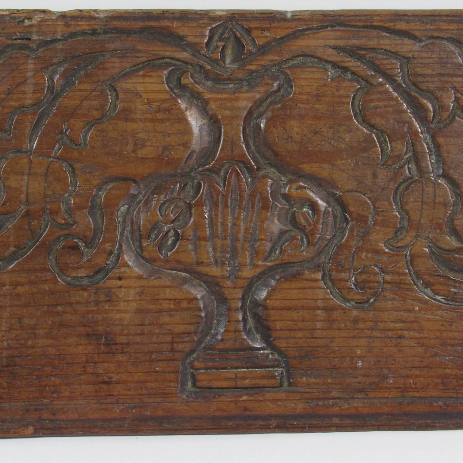 Antique Spanish carved wood architectural element with floral and urn carvings used as a wall plaque. Bears label 