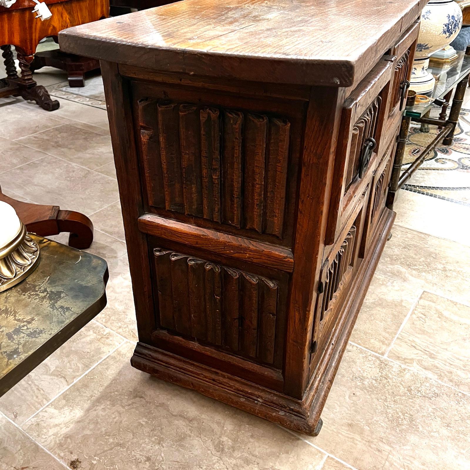Antique Spanish circa 1920s carved wood cabinet with 2 drawers and 2 doors.

Measurements:
Height: 31
Length: 41