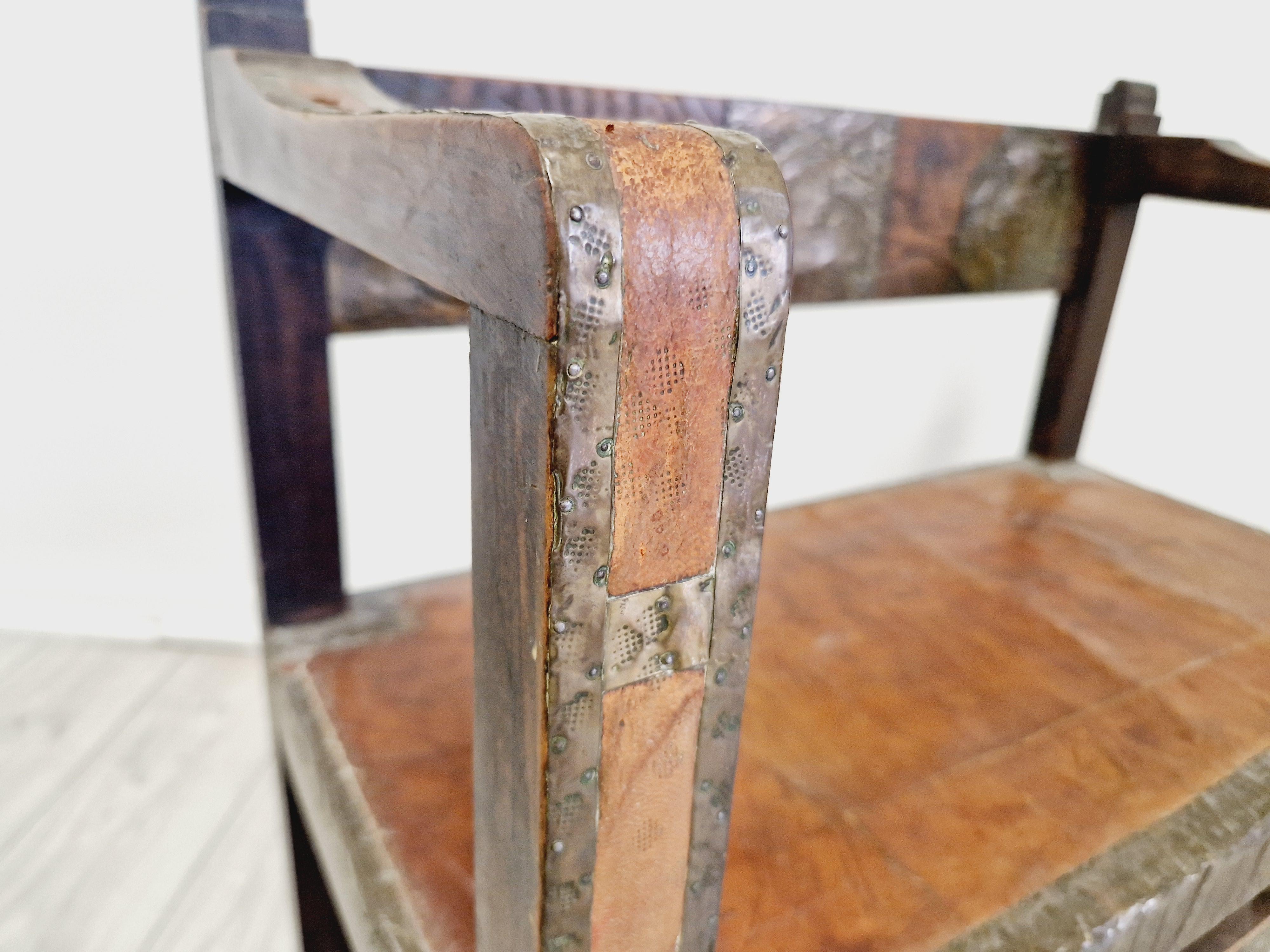 Add a touch of colonial charm to your home with this beautiful antique Spanish chair. Crafted from wood, brass and leather, this fully assembled armchair measures 70cm in length, 37cm in width and 75cm in height. The chair features intricate