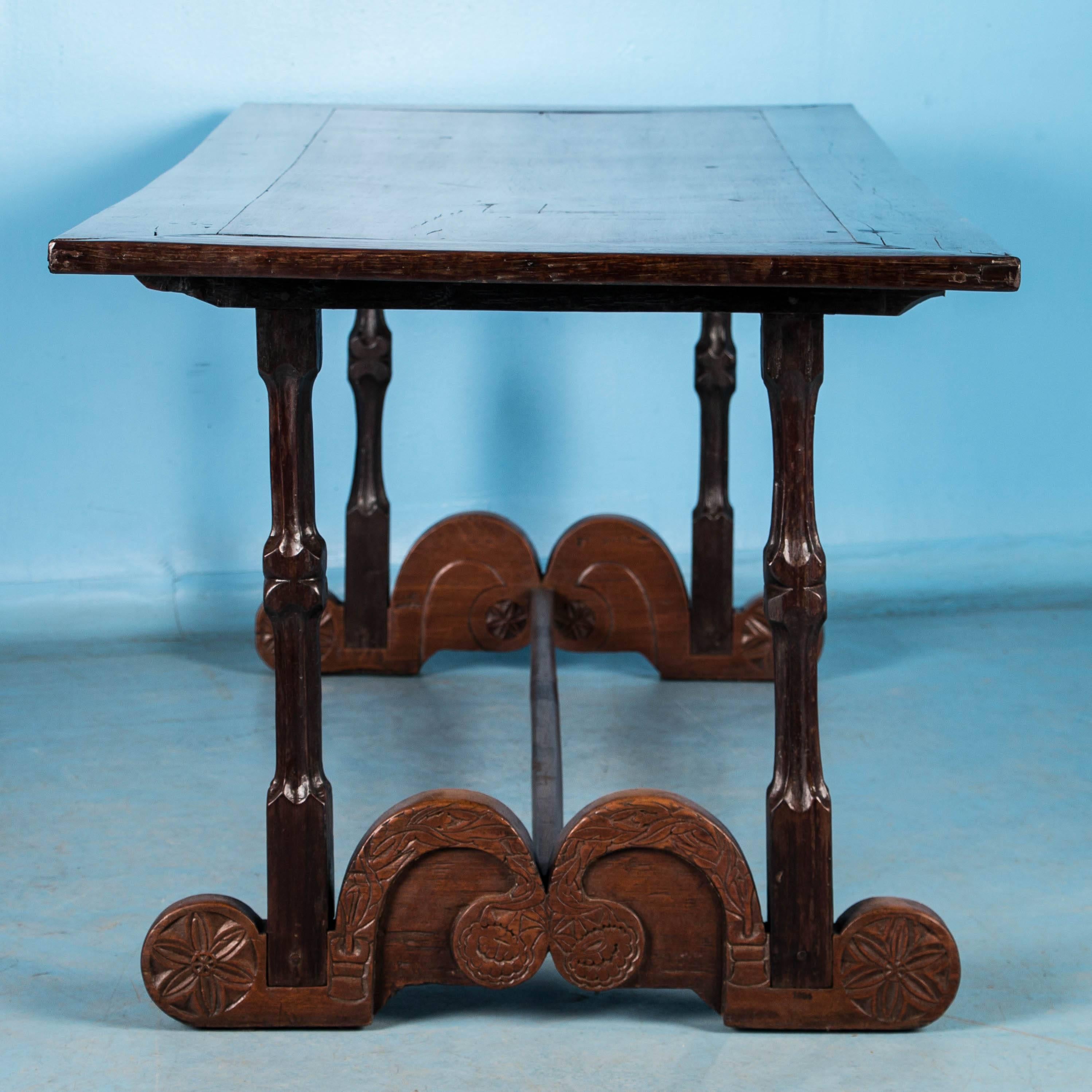 Blending craftsmanship and design, this long handcrafted table is stunning with it's contrasting light and dark hard wood top, sculpted legs and heavily carved scrolled feet. Made from endemic Philippine hardwoods, possibly molave and narra wood,