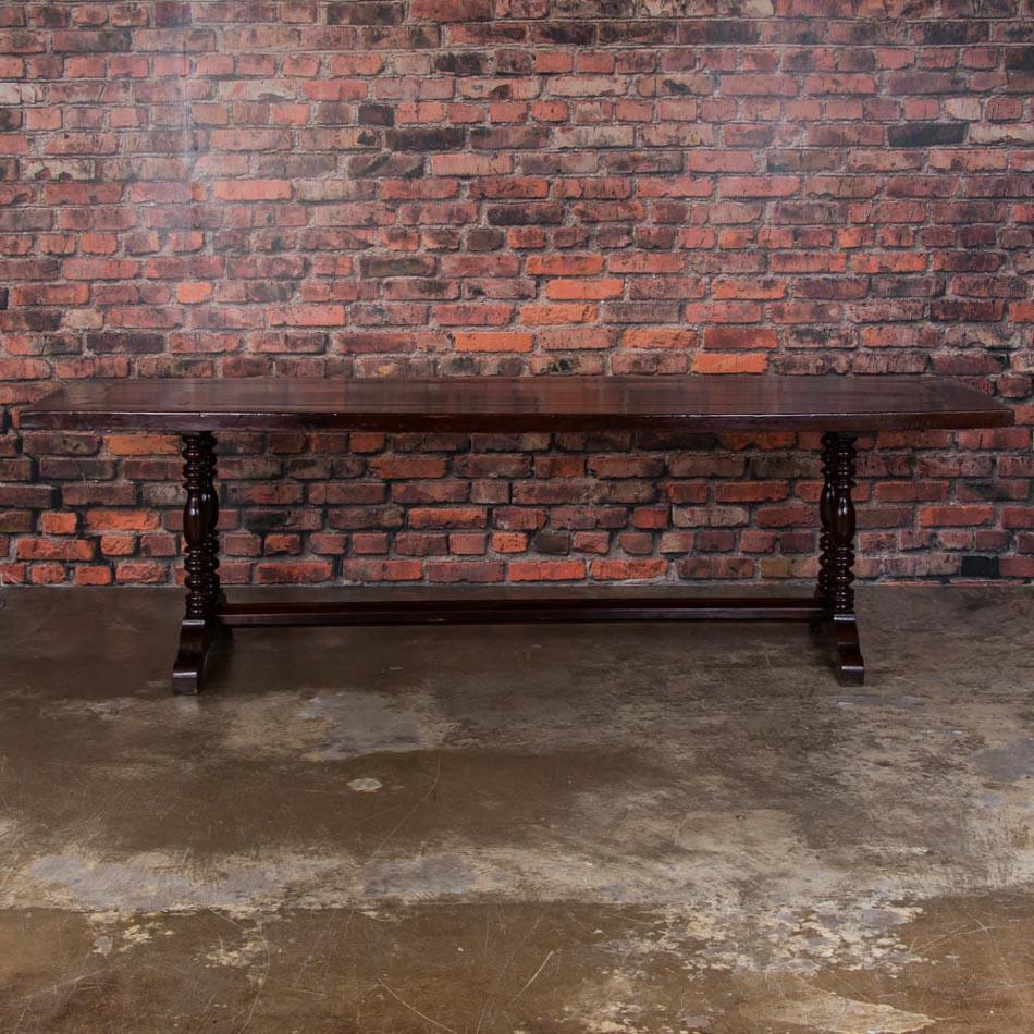 Blending craftsmanship and design, this long handcrafted table is stunning with it's rich, mahogany colored top and sculpted legs. Made from endemic Philippine hardwoods, possibly molave and narra wood, the table has a light open feel with the