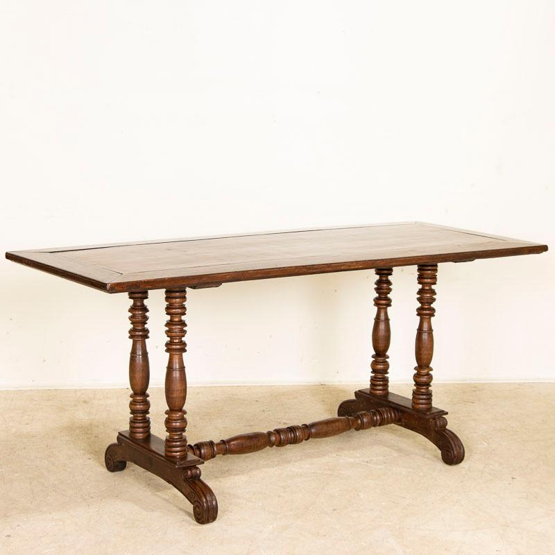 Blending Spanish colonial craftsmanship and design, this table is made from the beautiful and hard narra wood from the Philippines. The table has a light open feel with the attractive turned legs and trestle base, accented with the sculpted/carved