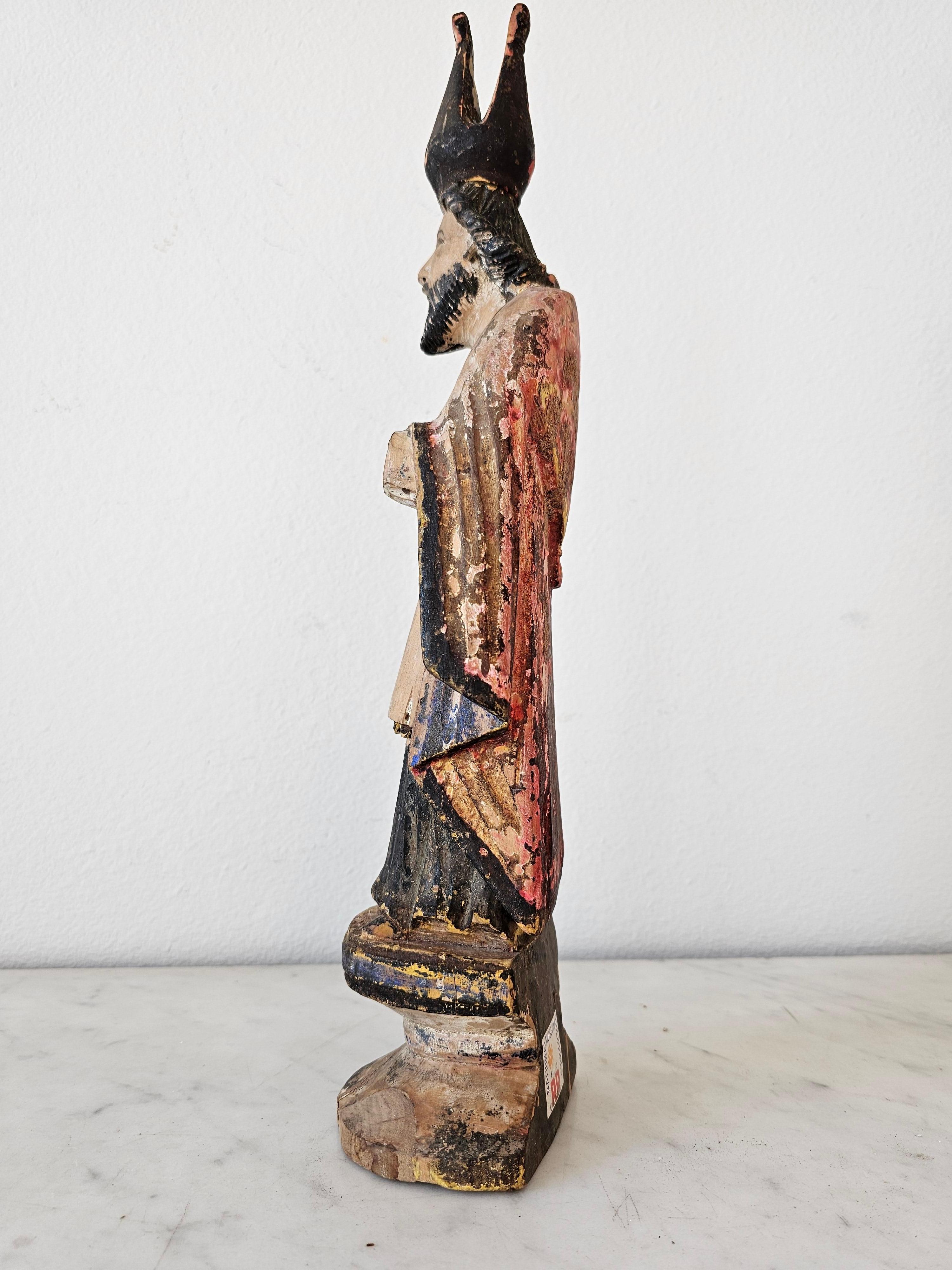 A scarce Spanish Colonial Hispano-Philippine hand carved santo altar figure sculpture. circa 1810

Handmade by Spanish settlers / colonists in the Philippines, late 18th / early 19th century, Bishop Saint, likely depicting Saint Isidore of Seville,