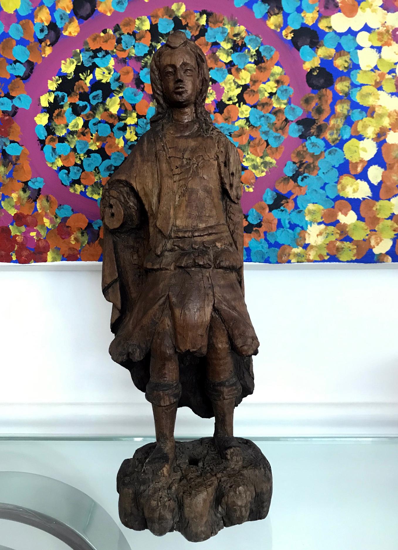 An very well weathered Spanish-colonial Santo, likely depicting St Michael or St Miguel. Carved from the wood, the statue displays historical loss on both limbs and also the wings on the back, as well as the base, but also tremendous patina and