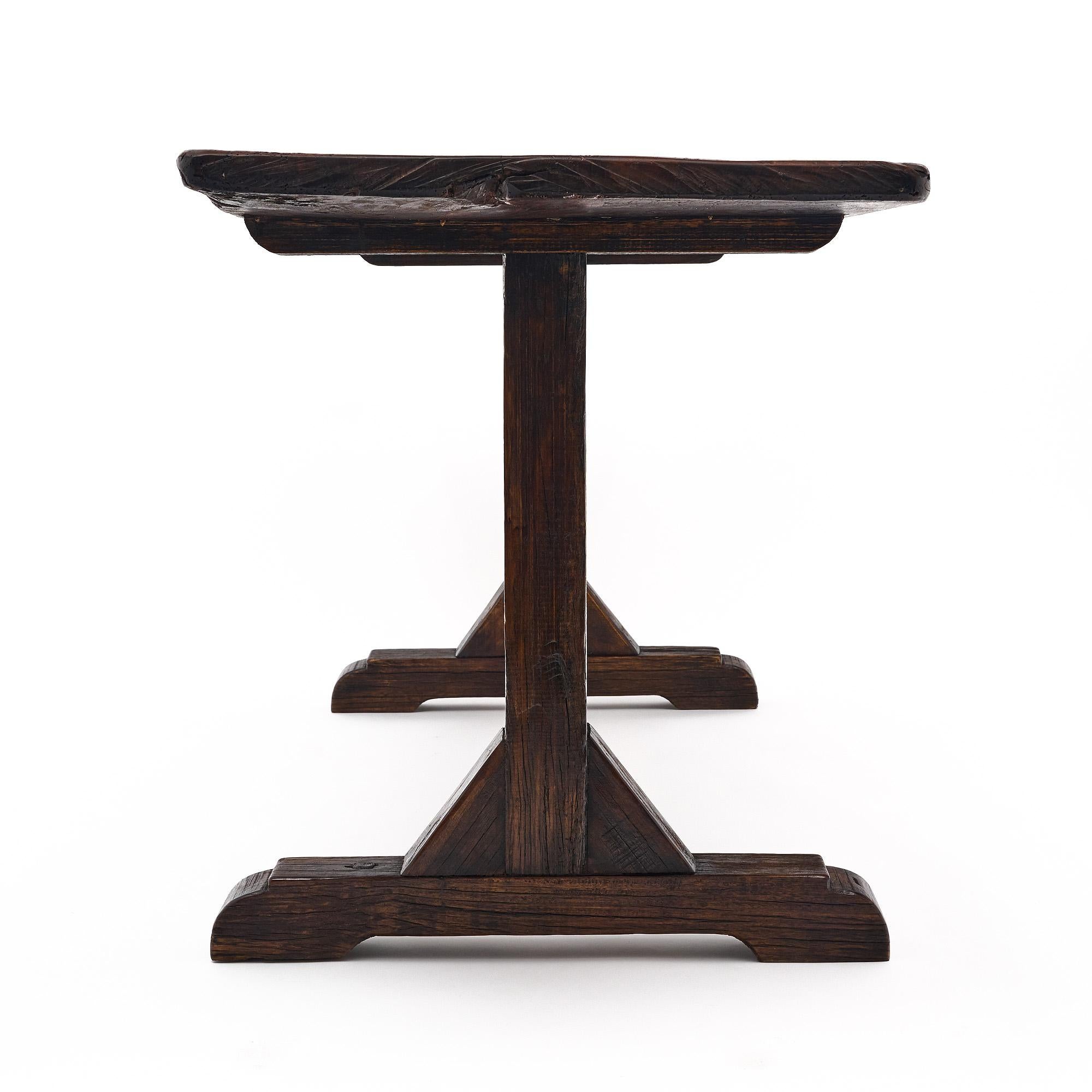 Farm table, from Spain, made of patinated chestnut. The Antique console features a single 18th-Century plank top on a reconstructed antique base of reclaimed beam.
