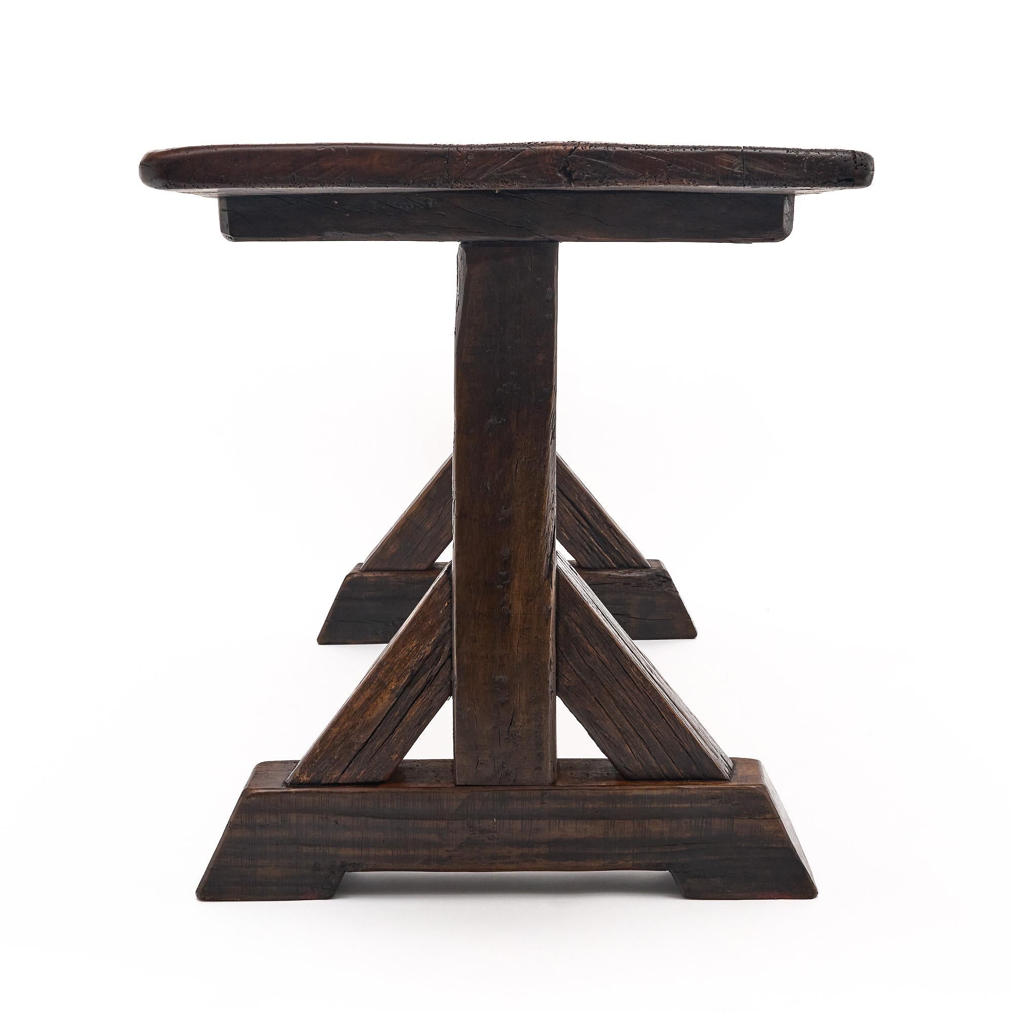 Farm table, from Spain, made of patinated chestnut. The Antique console features a single 18th-Century plank top on a reconstructed antique base of reclaimed beam.
