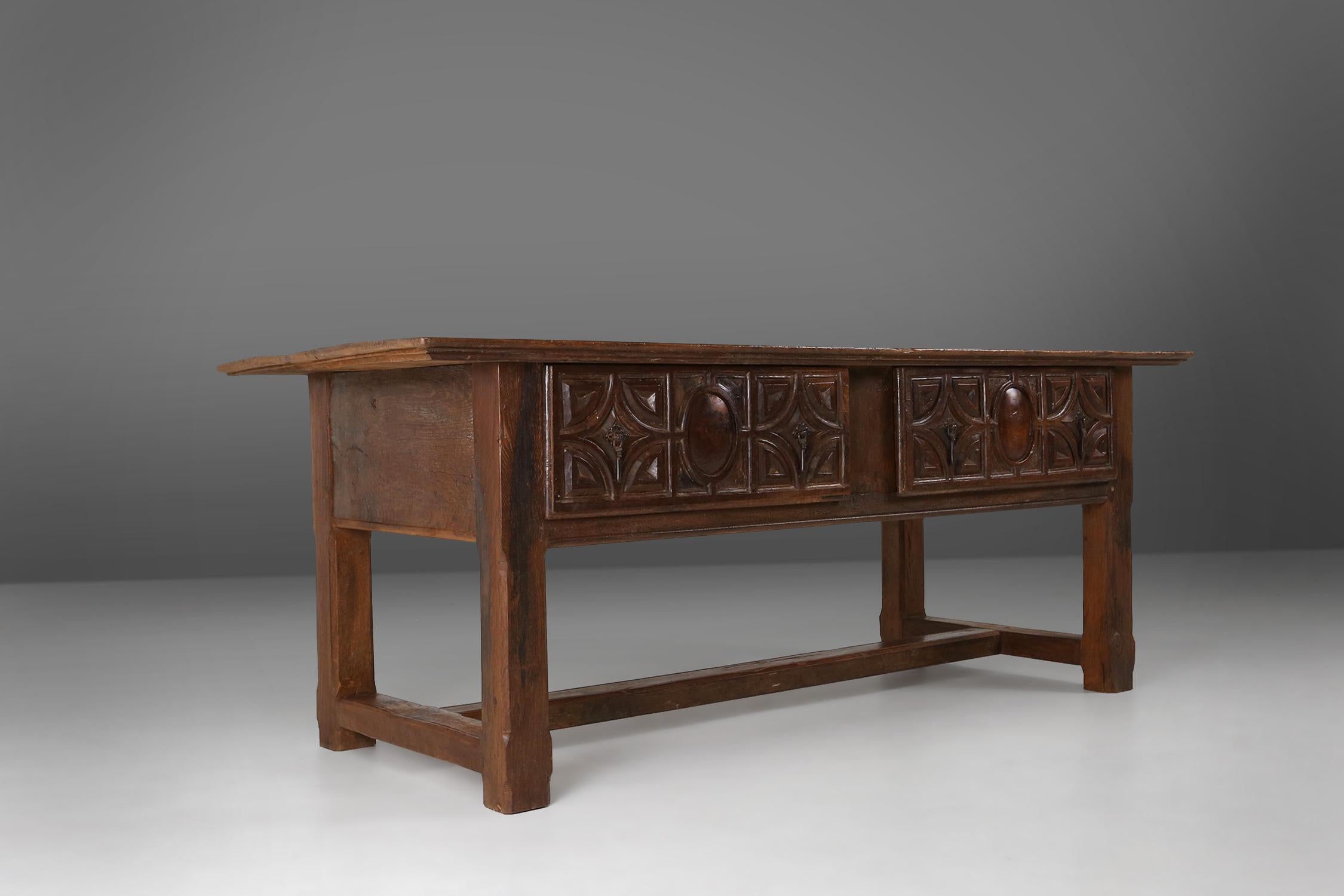 An exceptional antique Spanish console table in oak wood, with 2 large drawers and beautiful craftwork from from the 18th century. This exquisite piece of furniture with  two large drawers, providing ample storage space for your belongings. Hand
