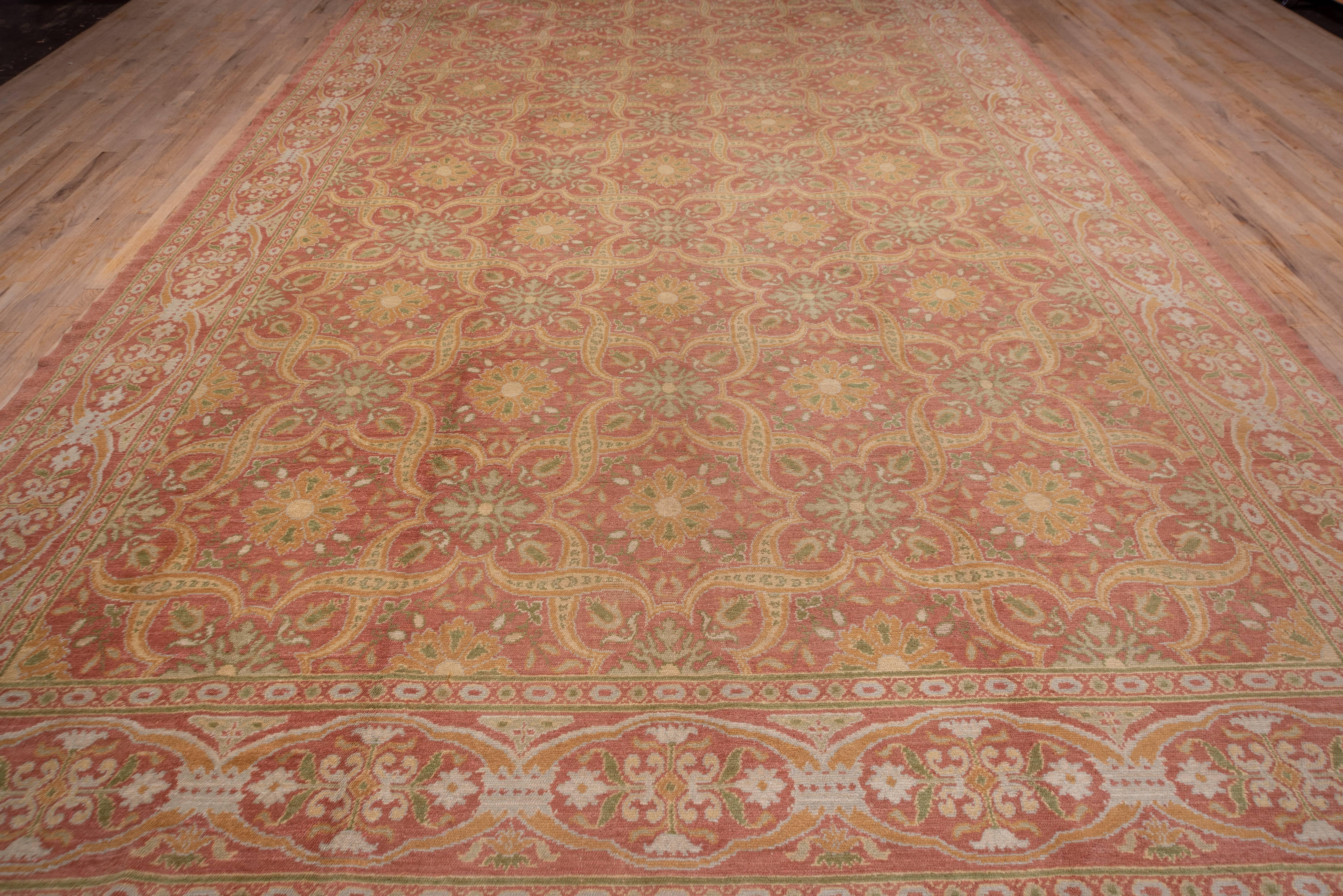 From Cuenca, this single warp knot carpet has a tawny ground with a twisted strapwork pattern defining octogramme and quatrefoil reserves enclosing rosettes and flowing stars. The connected oval cartouche border is on the same tawny ground tone and