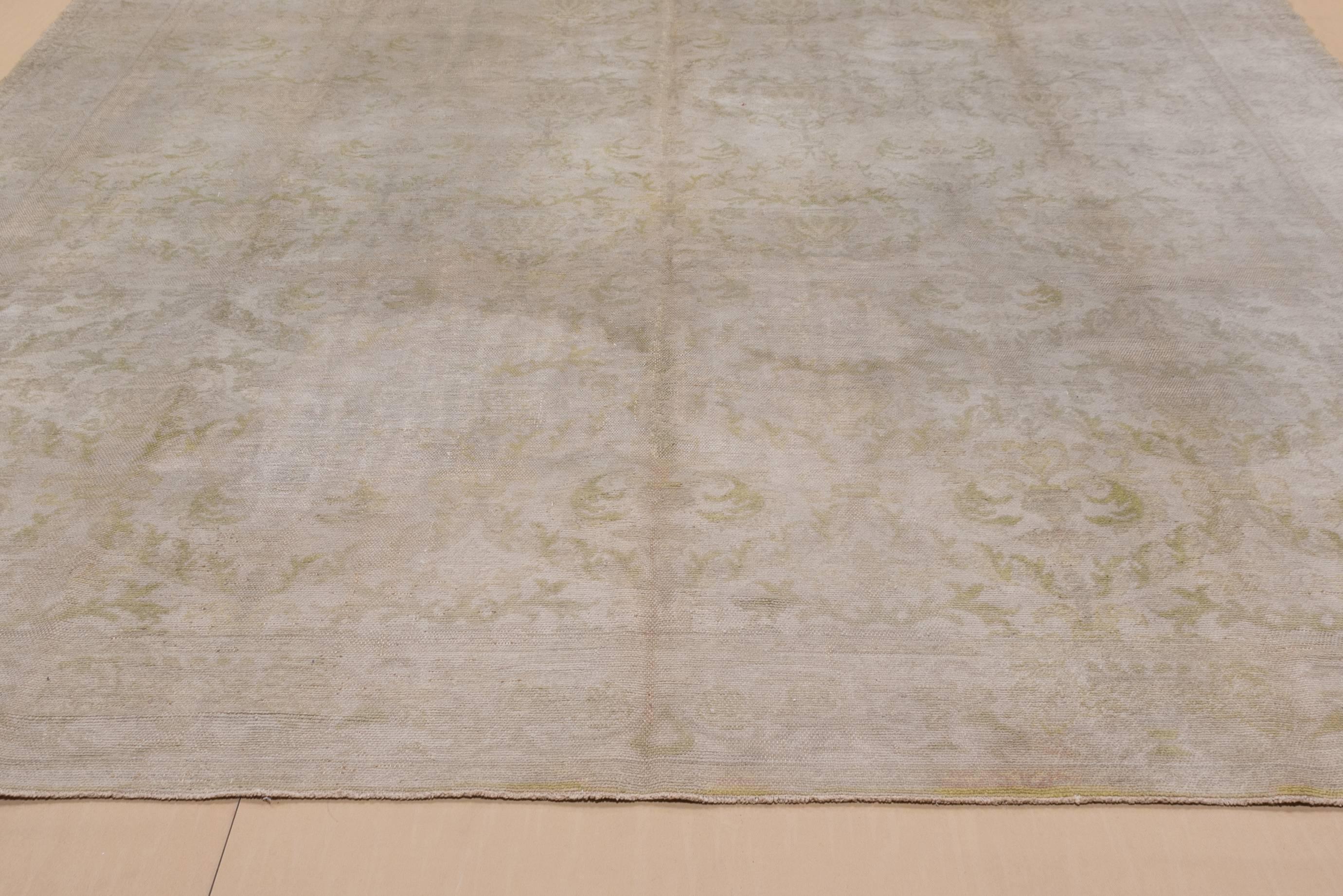Woven with the single warp knot, this lightly toned Spanish carpet has a vase and wreath pattern accented in soft yellow on the general beige ground.