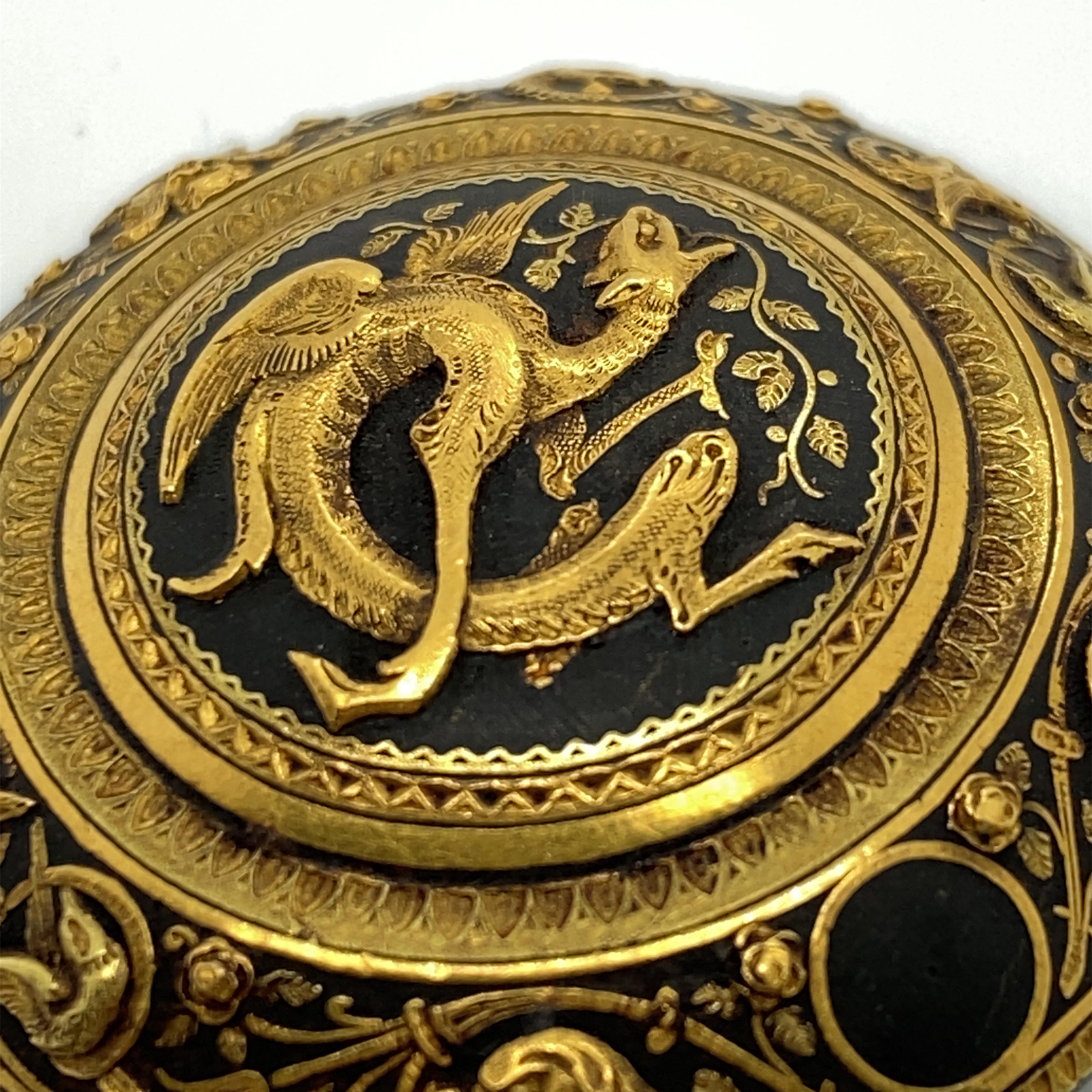 This antique 'Damascene' dragon-motif brooch originated in Spain during the Victorian era; all elements - from the placement of the decorations to the subtle texturing visible on many of the individual elements - would have been painstakingly