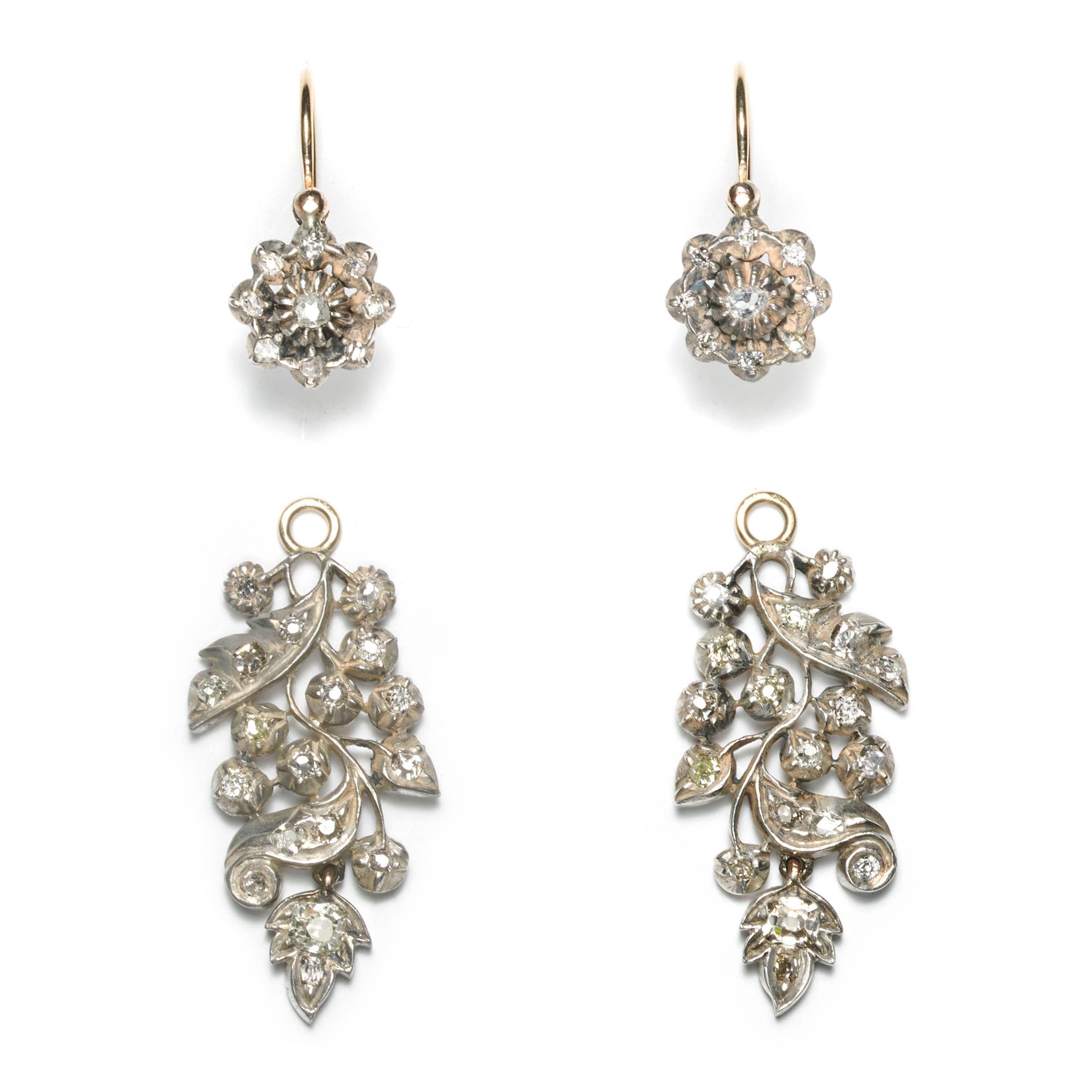A pair of antique diamond and silver-upon-gold drop earrings. The tops have an old-cut diamond in each centre, in a heavy claw setting, with eight, surrounding old mine-cut diamonds, in cut down settings; the drops are set with old mine-cut