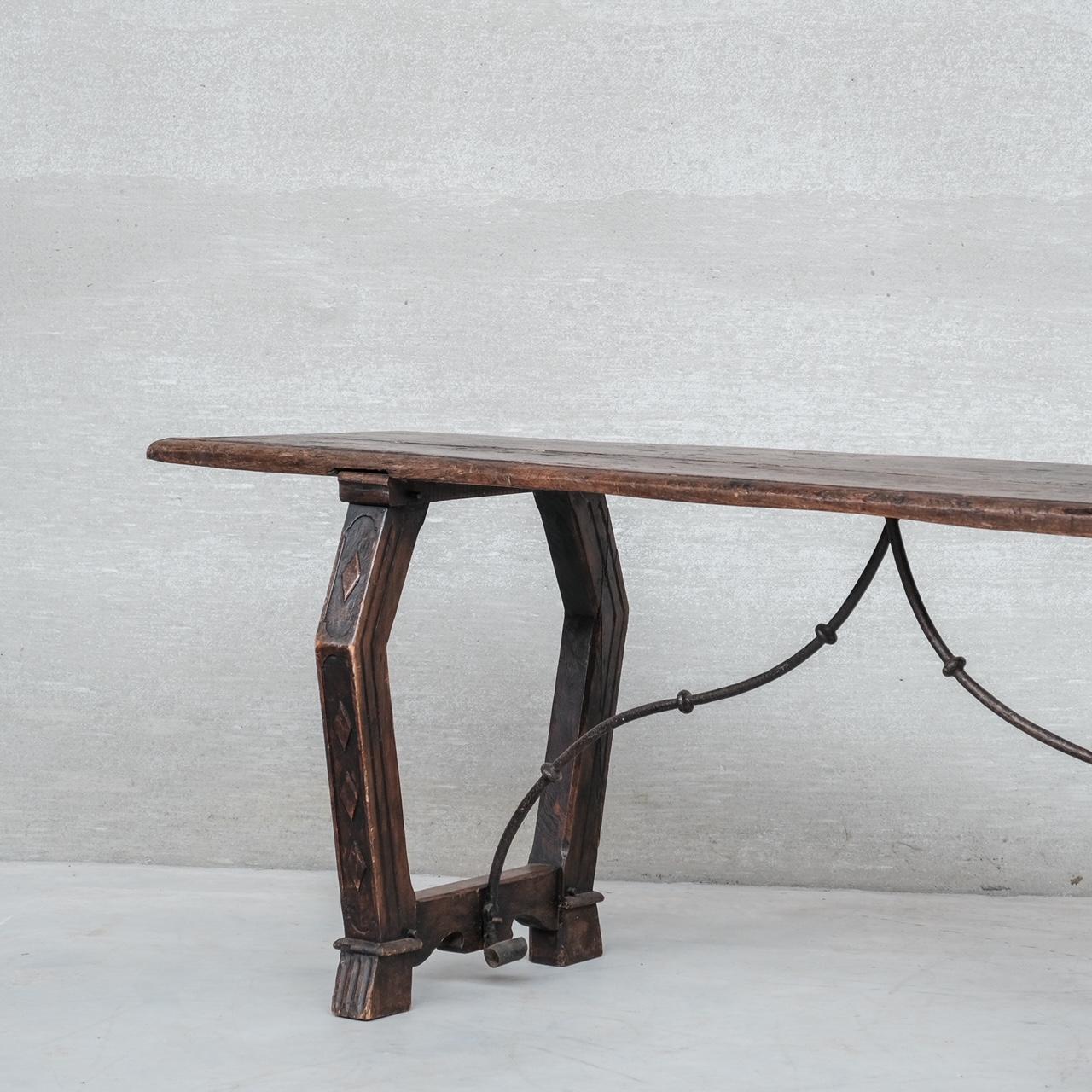 An antique console, with double sided simple decoration to the legs.

Iron stretchers.

Spain, c1900s, likely earlier.

Good condition, wear commensurate with age.

Internal Ref: 24/04/24/023.

Location: Belgium Gallery.

Dimensions: 222 W x 72 D x