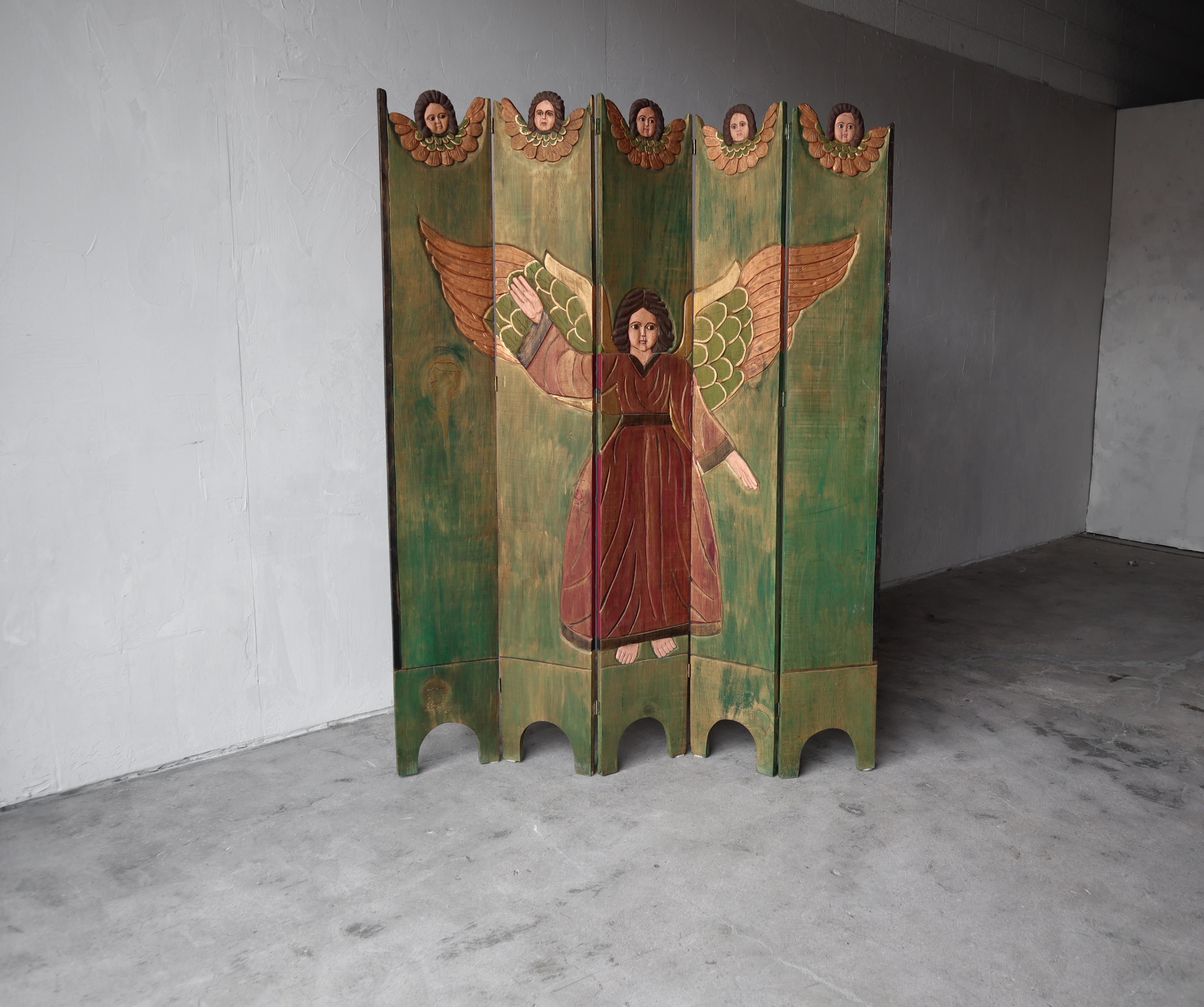 Miraculous 5 panel antique Spanish folk art, room divider. This gorgeous folding screen divider has been meticulously and identically hand carved and hand painted on each side.

Screen is in excellent condition with no damage to be noted.