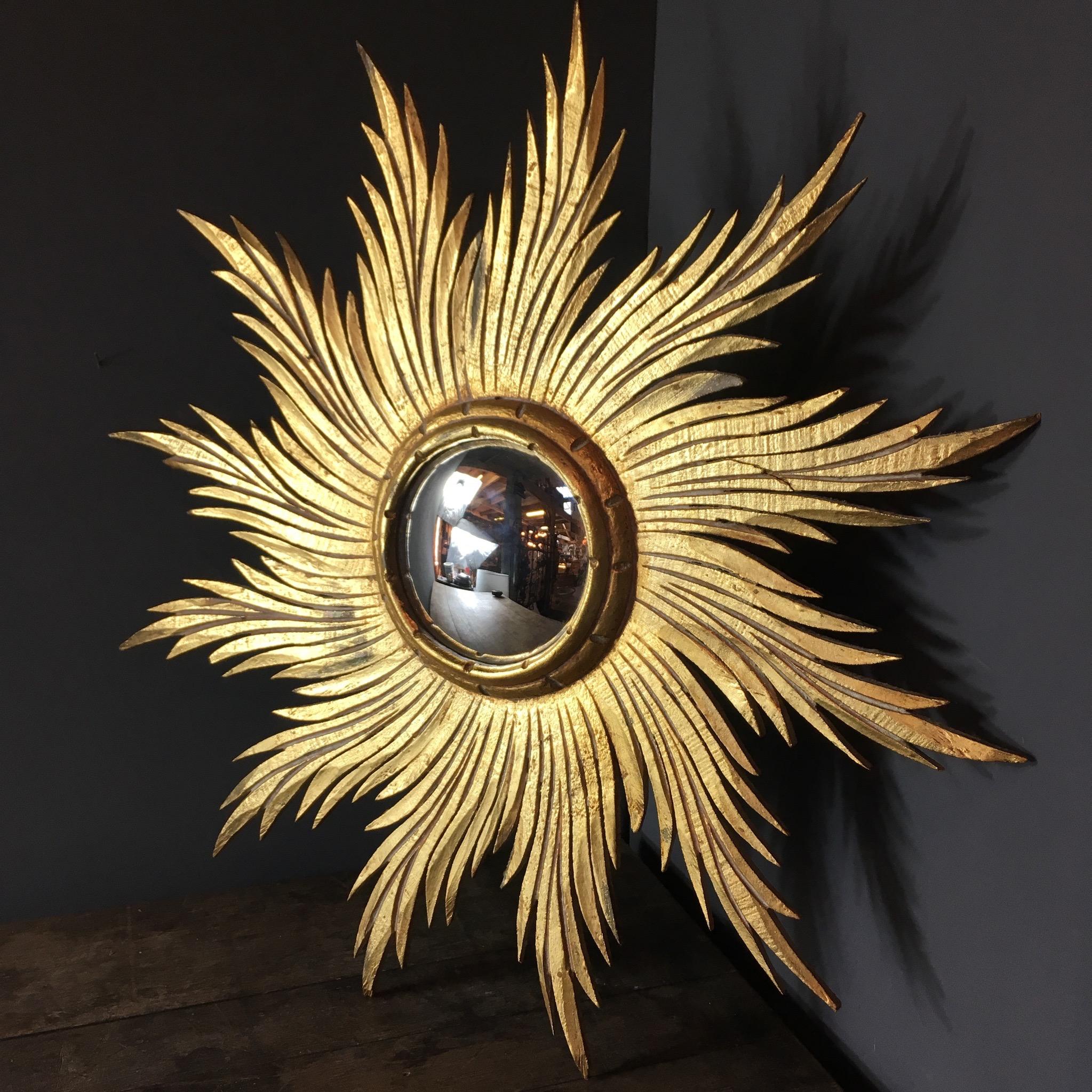 Antique Spanish wooden sunburst Mirror

Convex mirror

Beautiful spiked rays emit from the central convex mirror

Measures: 59.5cm width
14.5cm width of convex mirror

Hanging hook on reverse

One of the longest points has lost a small part of its