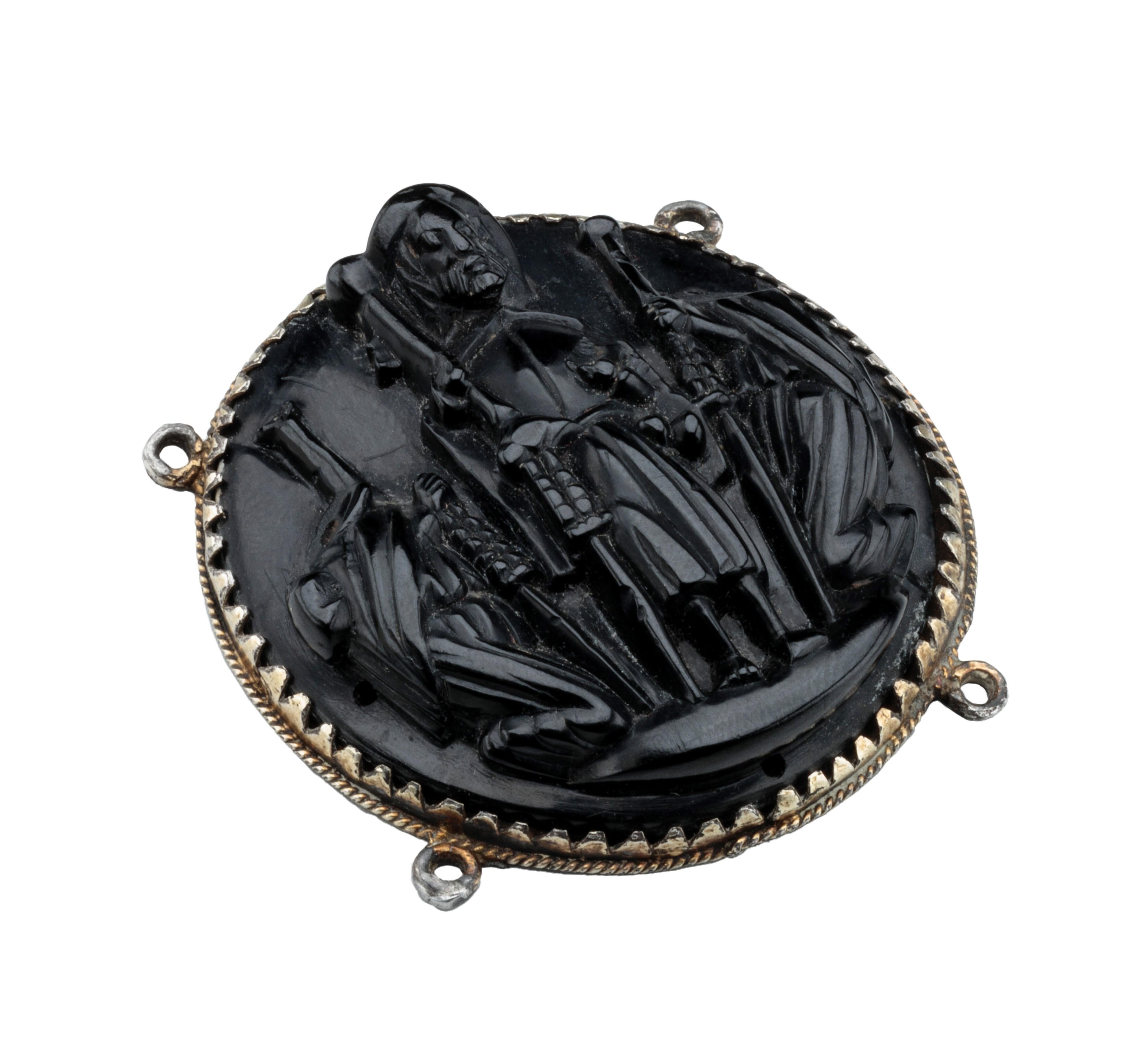 BADGE WITH ST. JAMES THE GREAT 
Northern Spain, 16th century 
Silver, jet 
Weight 18.2 grams; dimensions 44 × 43 × 12 mm

Round pendant with high-relief image of St. James the Great of Santiago de Compostela carved in jet. The saint is flanked by