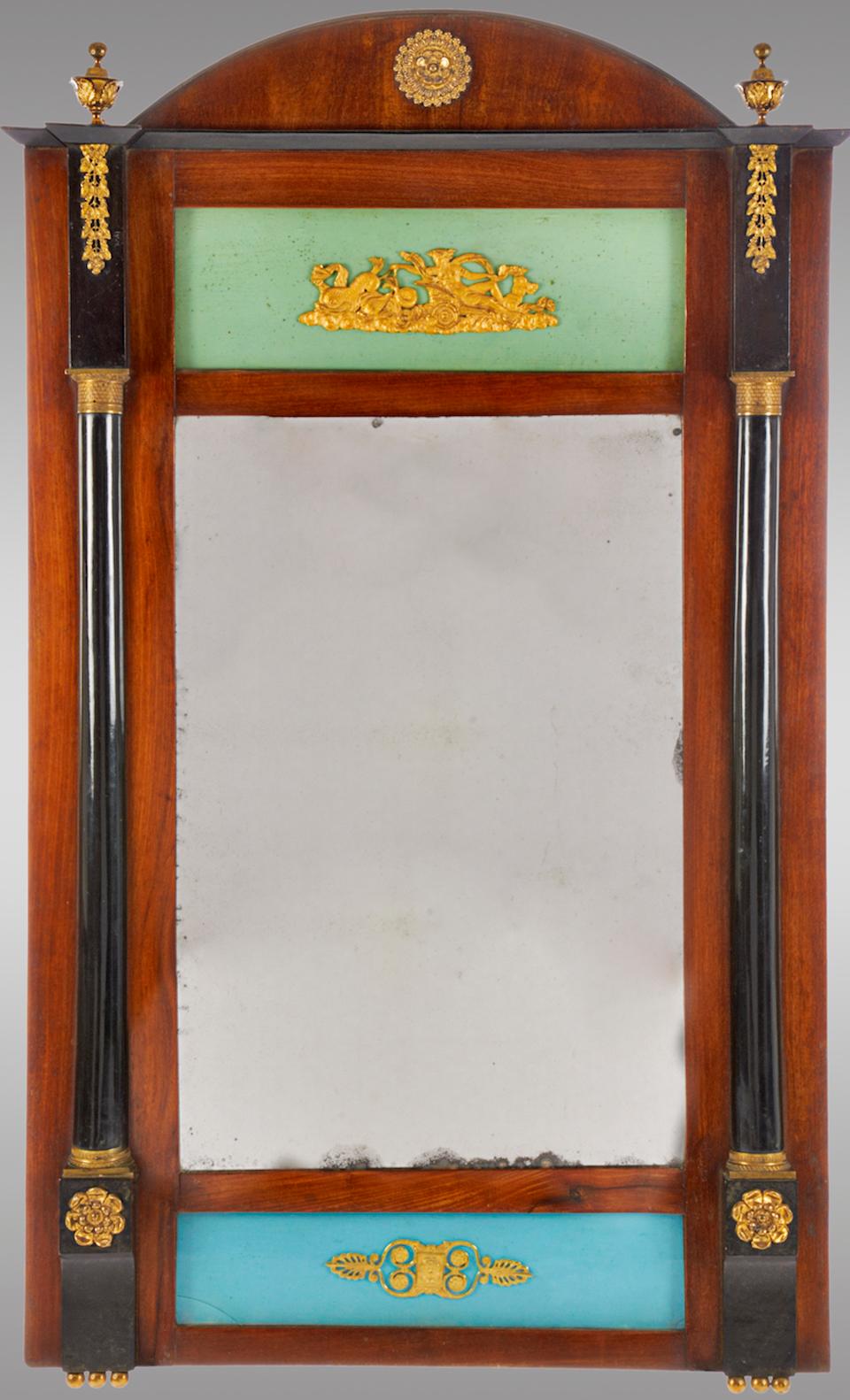 This antique trumeau was designed during the Ferdinand VII period and manufactured during the early 19th century. The mirror features a mahogany frame with ormolu details. In very good antique condition with minor wear consistent with age and use.
