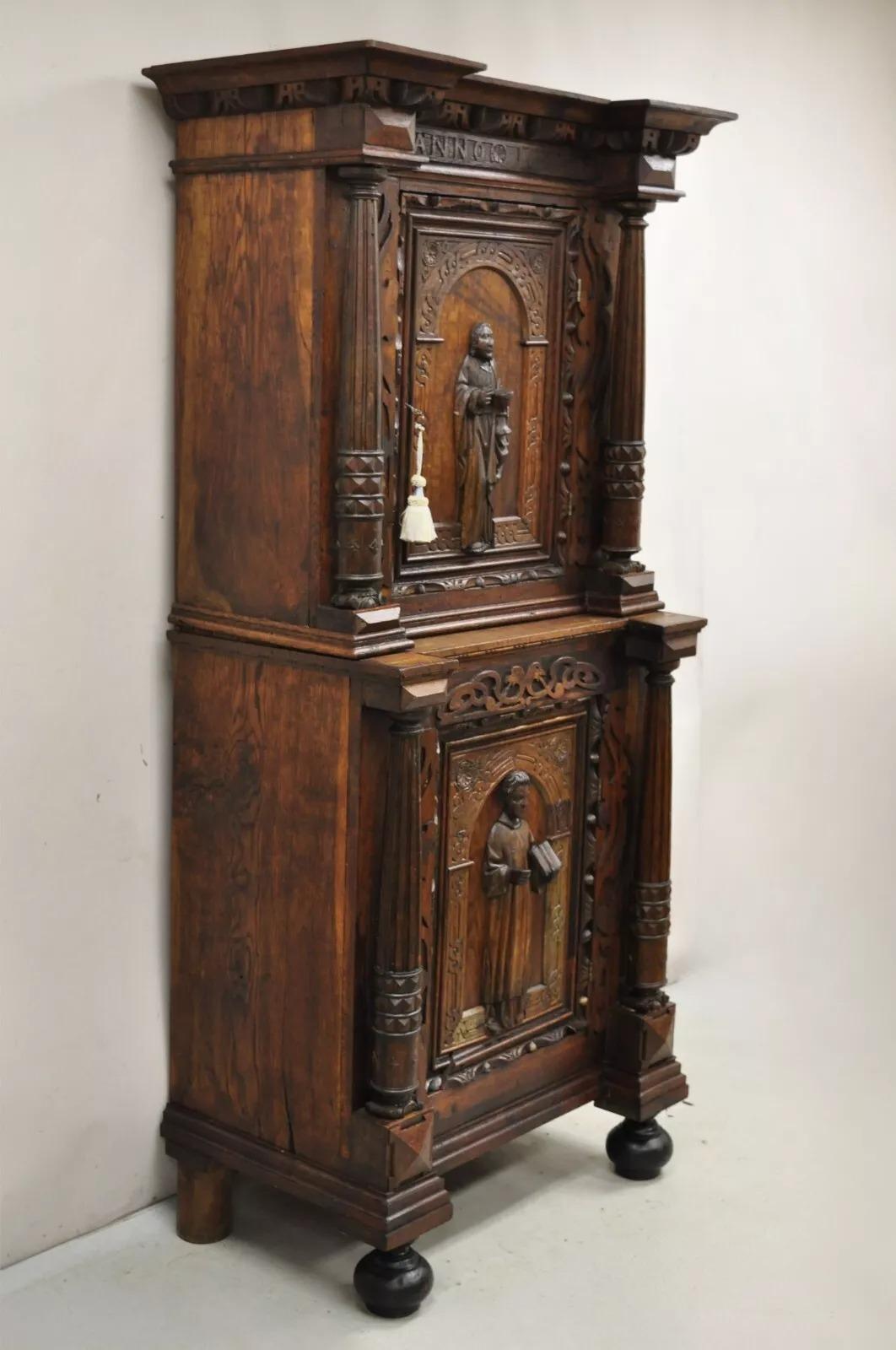 Antique Spanish Renaissance Figural Carved Oak Wood 2 Pc Religious Cupboard Cabinet. Item features solid wood two part construction, carving that reads 