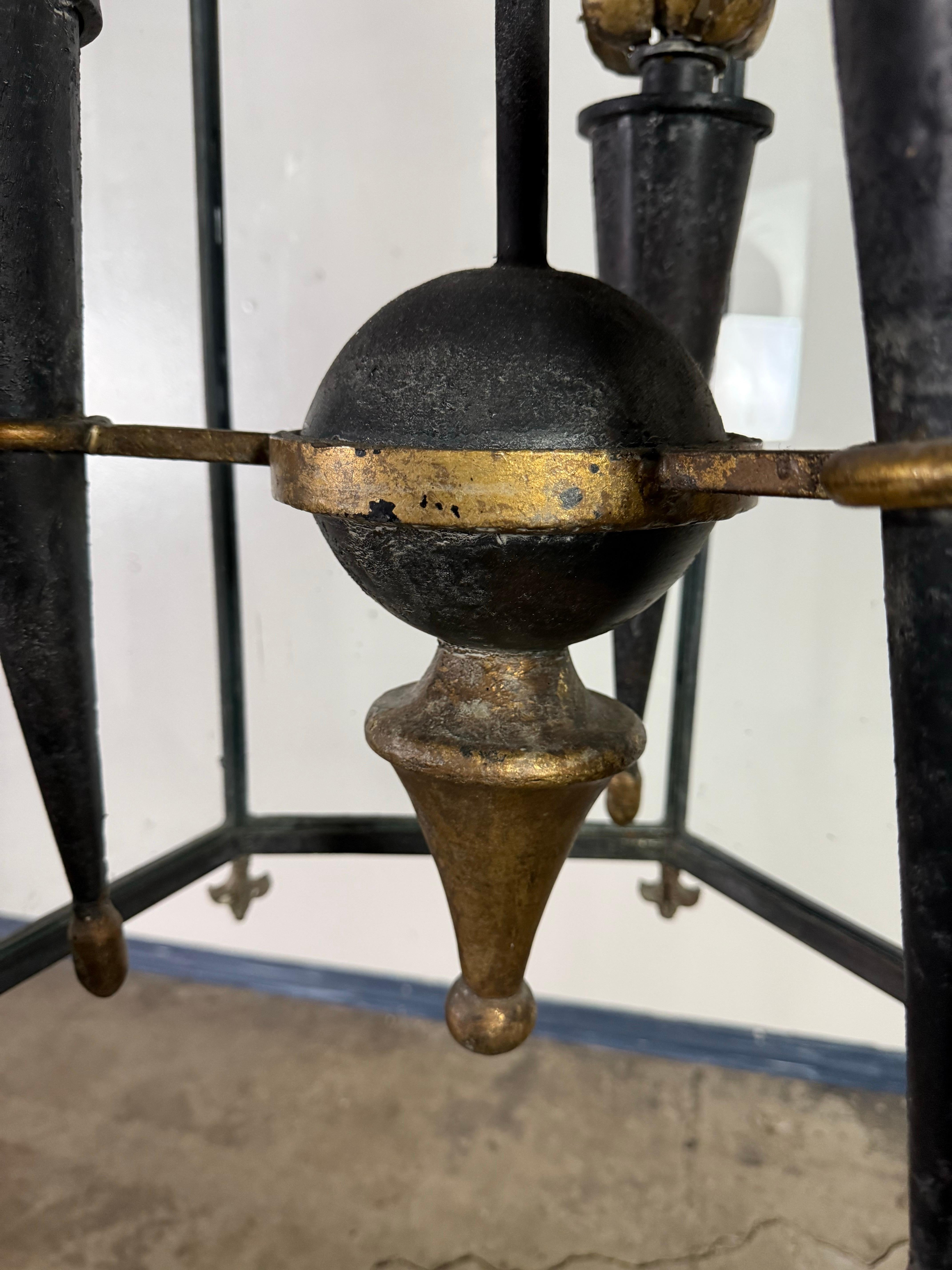 Eine atemberaubende Hängelaterne aus dem frühen 19. Jahrhundert im spanischen Revival-Stil mit einer dramatischen vergoldeten Metallkrone über einem handgeschmiedeten sechseckigen Rahmen aus schwarzem Eisen. Jede Ecke ist mit zierlichen