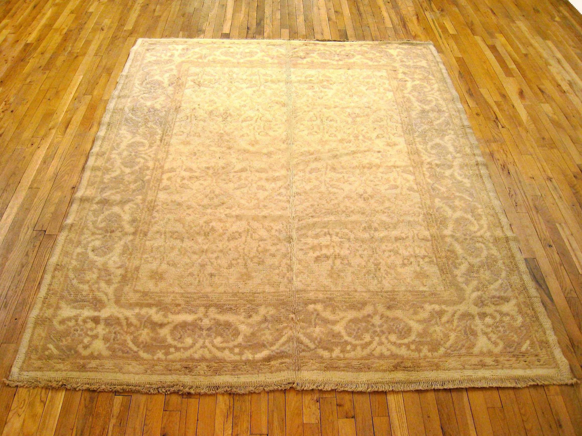 Antique Spanish rug, Room size, circa 1920

A one-of-a-kind antique Spanish Carpet, hand-knotted with short wool pile. This beautiful rug features a diamond design allover the ivory primary field, with an ivory outer border. In room size, size