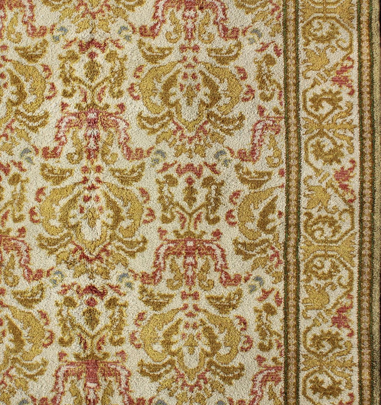 Elegant antique Spanish rug with floral design in light brown, acid green, yellow green, coral and white. Rug 16-0924, country of origin / type: Spain / Arts & Crafts, circa 1930

This elegant Spanish carpet (circa 1930) is the proud heir to a
