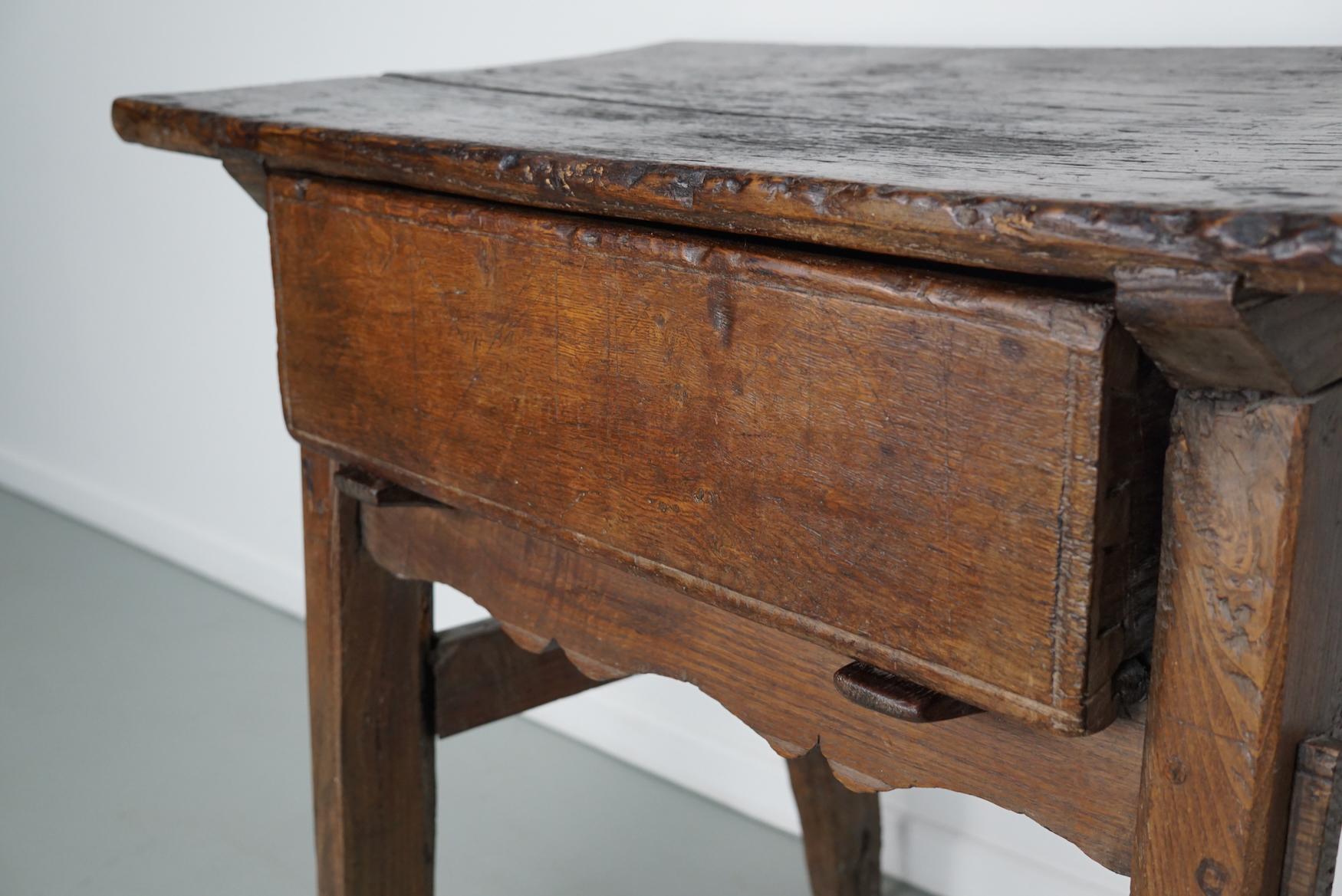 This elegant table was made in Spain from chestnut with beautiful grain patterns. It has a warm color with many marks of use, natural distressing and a great patina.