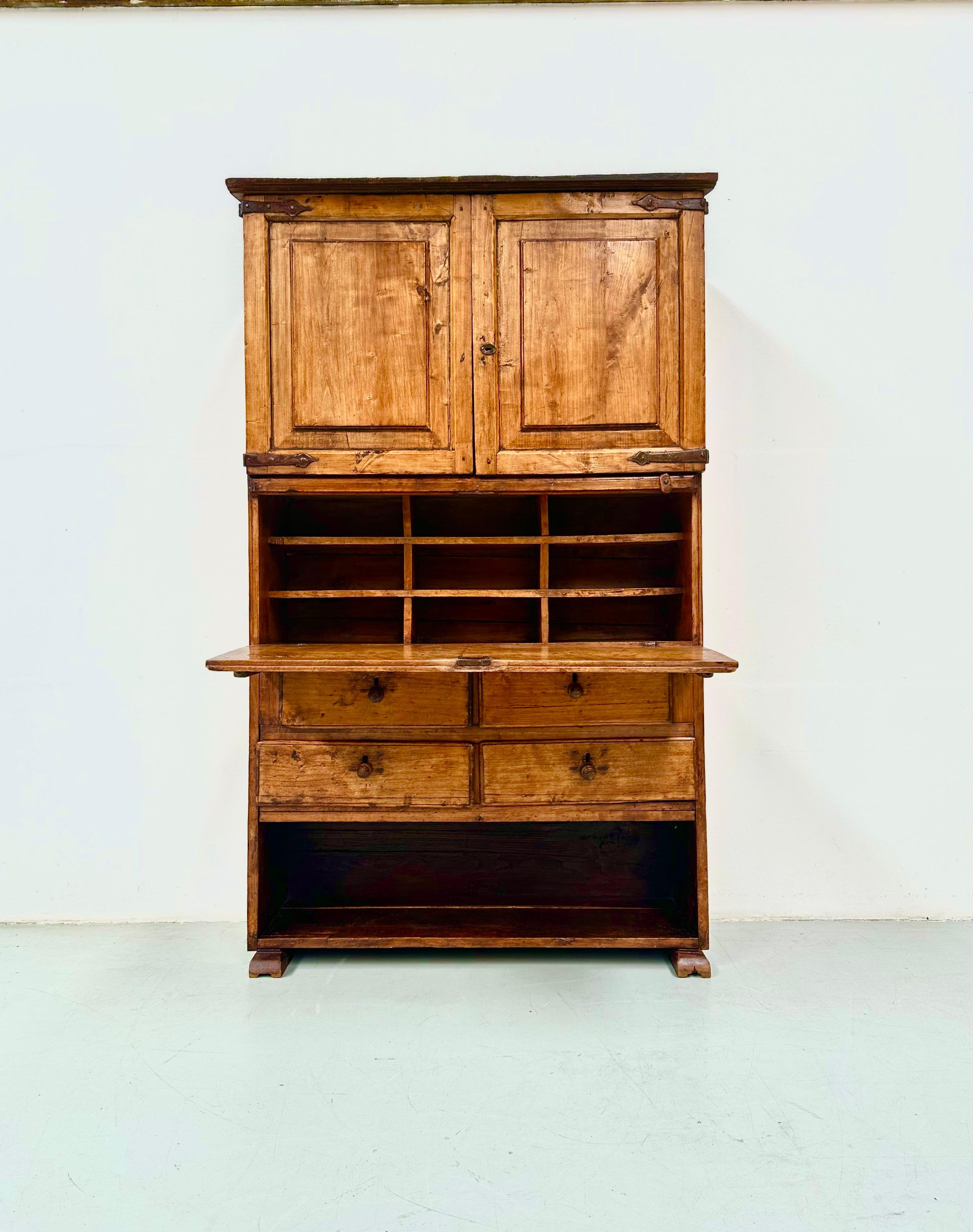 This secretary cabinet was handmade in Spain from fruitwood. Manufactured  around 1860 considering the forged nails and the ironwork. In very nice condition. Great patina in the wood. And no structural issues.