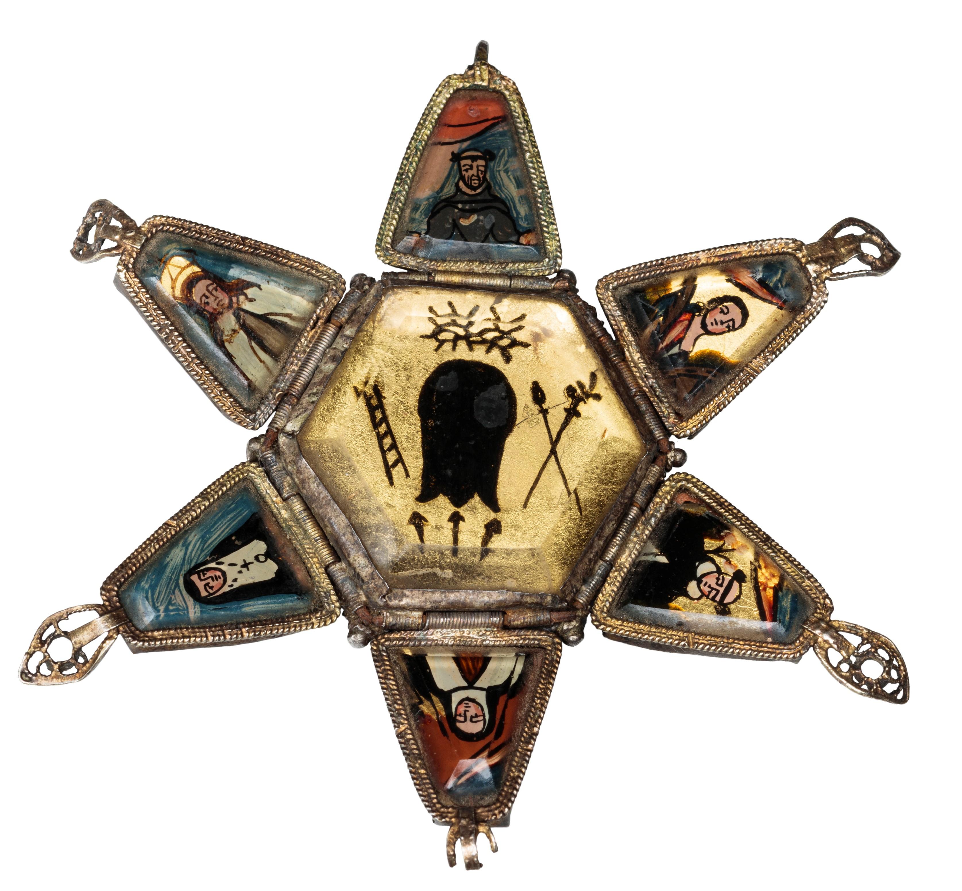 DEVOTIONAL PENDANT  
Spain (Jaén), 17th century  
Gilded silver, verre églomis�é  
Weight 28.7 grams; dimensions 71 mm (opened), 29 × 37 mm (closed)  

Gilded silver filigree pendant with hexagonal base and ornate twisted-metal strip and corded wire