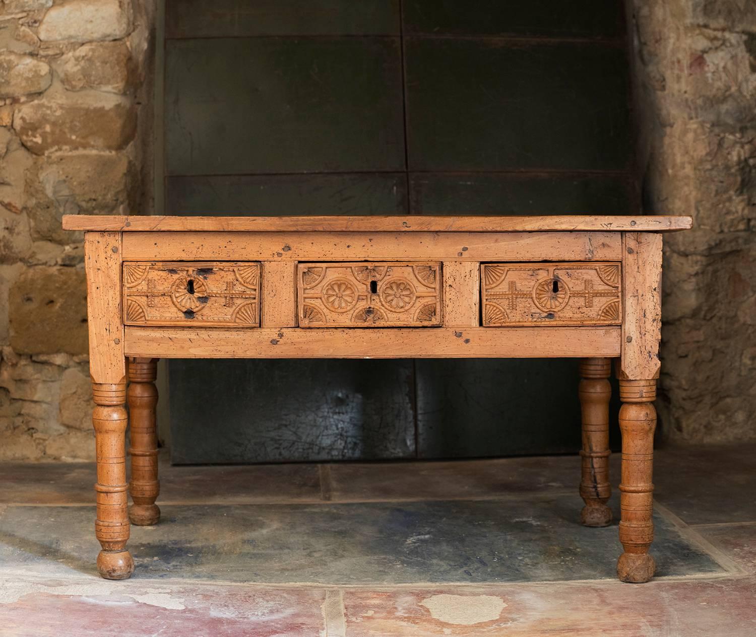 An outstanding 18th century table from Spain.
With three very deep hand carved drawers.
Elegant and warm patine from the years of use.
This table serves beautifully not only as a writing table but as a console as well.