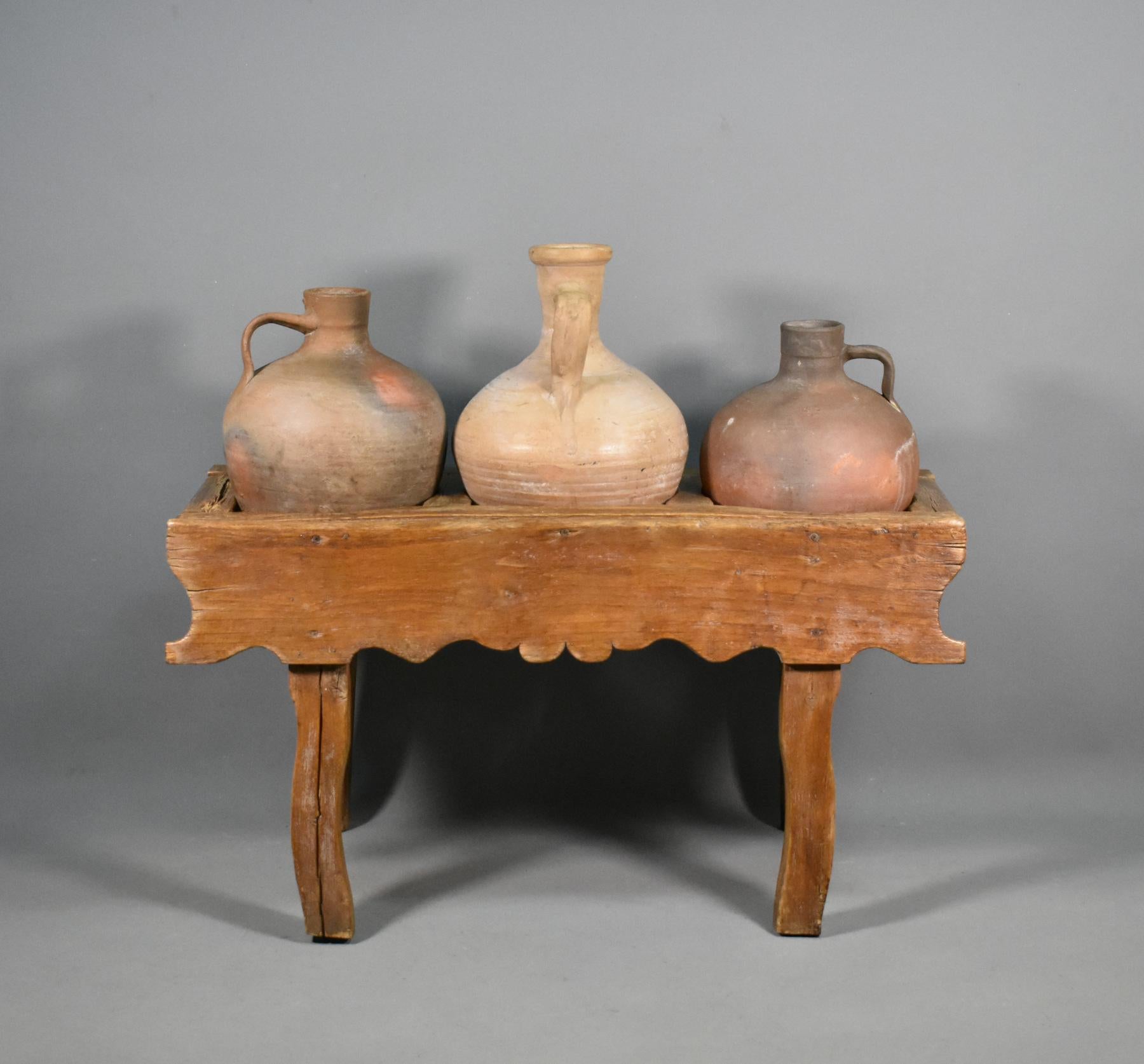 Antique Spanish Tinaja pots and stand.

A provincial Tinaja clay pot stand supporting three different tinaja clay pots. 

Originally designed for holding water, the beautifully aged pots show wonderful colouration. 

The pots sit comfortably