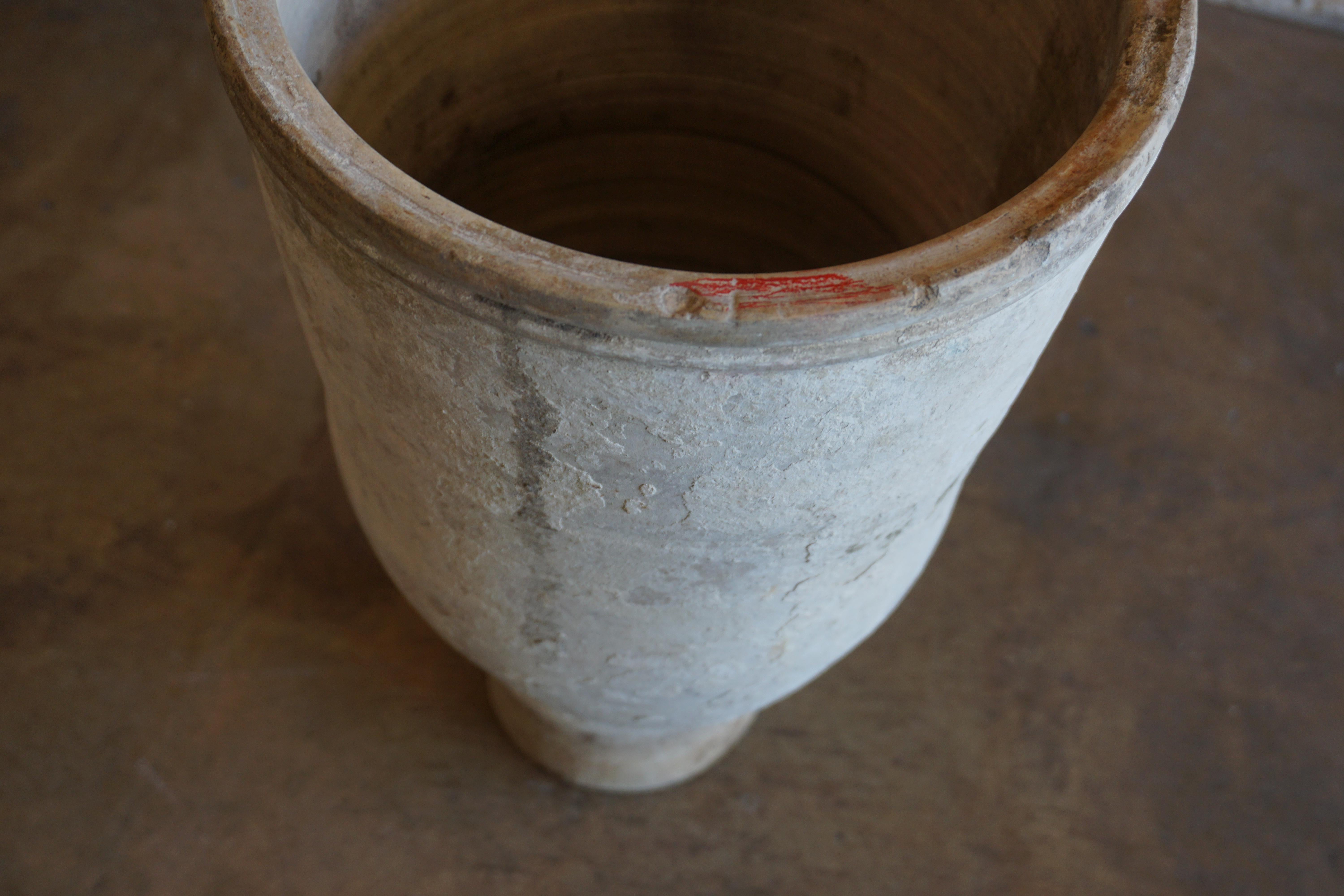 This white-washed terra cotta vessel originates from Spain, circa 1850. 

Measurements: 11.5'' D x 21.5'' H.