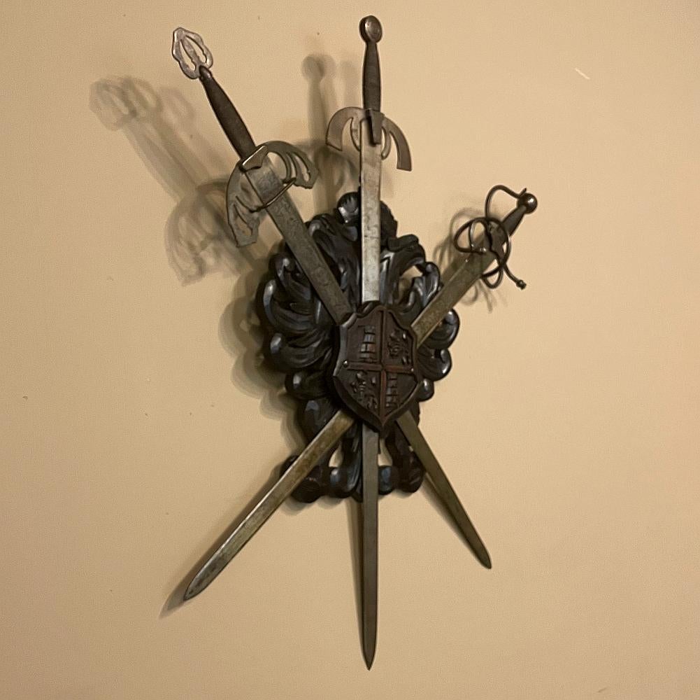 Antique Spanish wall crest with crossed sword display is perfect for the masculine decor! Forged in storied Toledo, each sword has been hand-crafted, with two showing hand-engraved embellishments and each displaying a different style of hilt with