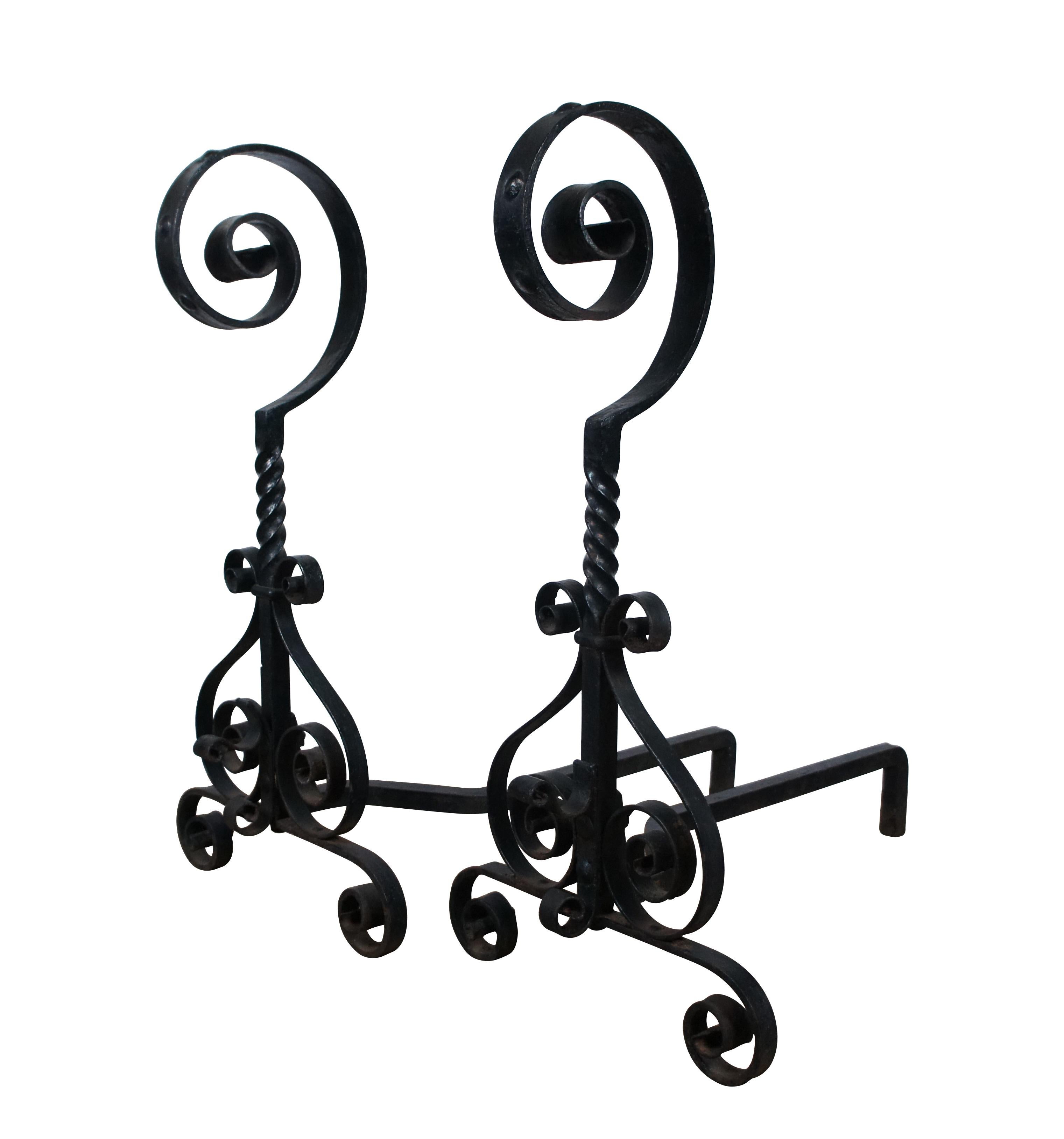 Antique Spanish Revival painted wrought iron andirons / firedogs featuring scrolled bases, twisted mid section and studded spiral tops.

Dimensions:
13