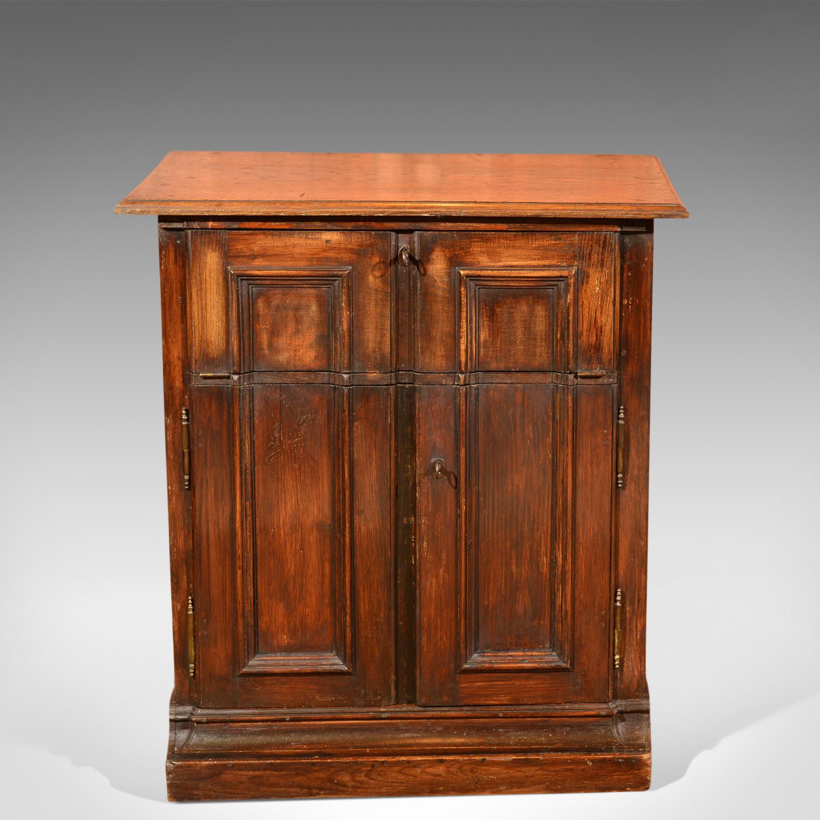 This is an antique specimen cabinet, a French, oak cupboard offering a secretaire desk dating to the late 19th century, circa 1850.

In a desirable French country style
Complete with original working locks and keys
Crafted in oak with grain