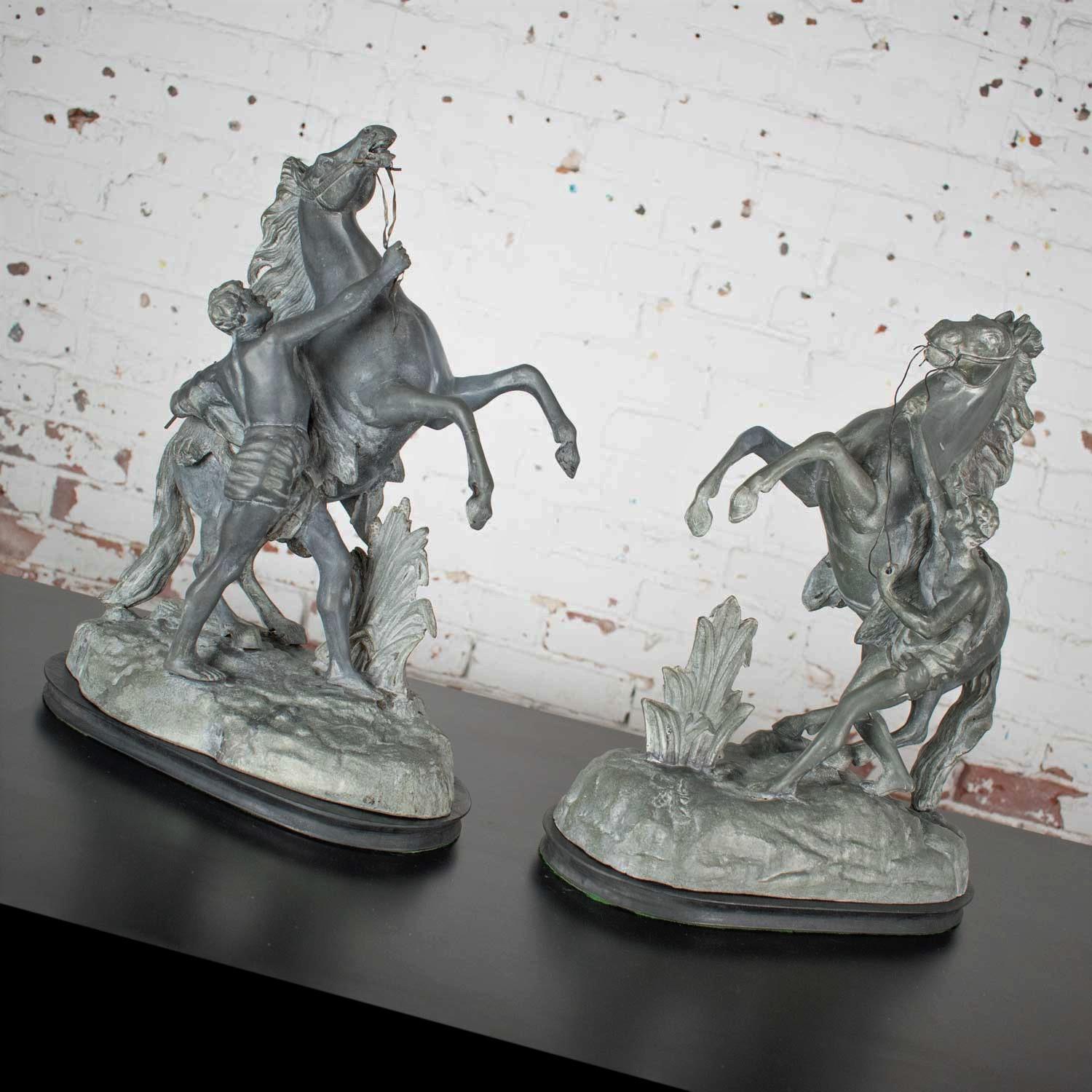 Fabulous antique replica spelter detailed sculptures of the Marly rearing horse and groom original stone sculptures by Guillaume Coustou. These replica sculptures were extremely popular in the Victorian era and were done by many artists. This pair