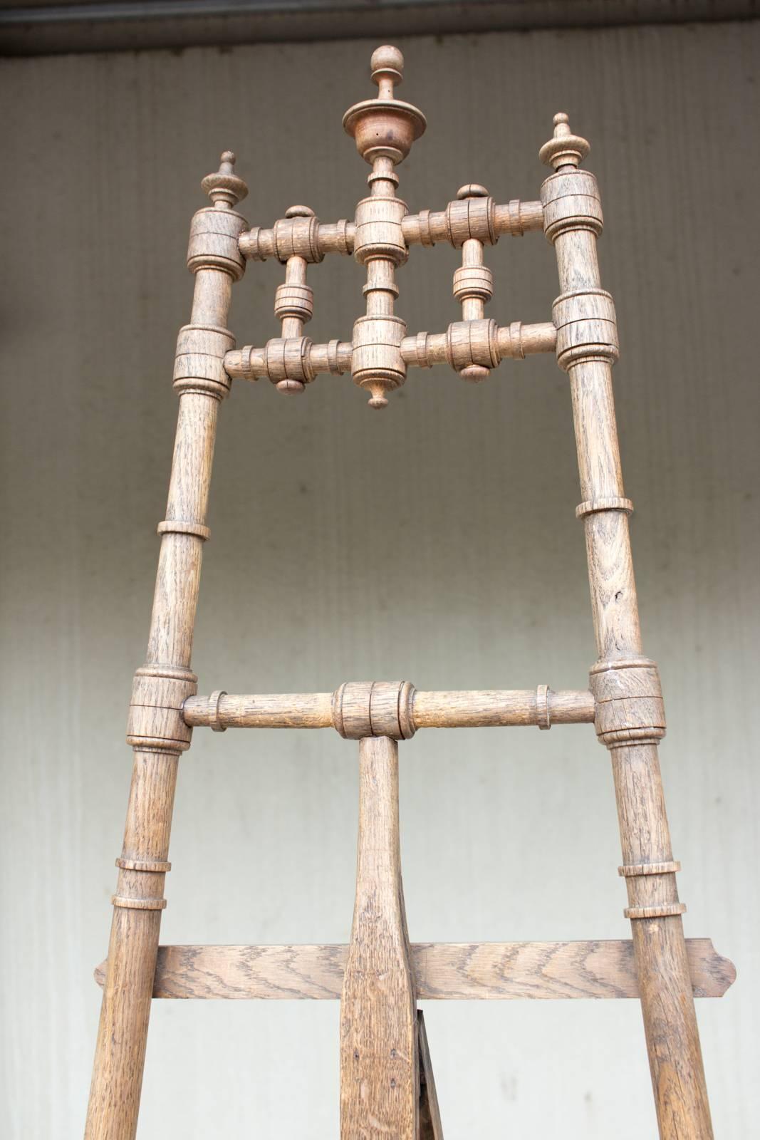 This antique wood easel was uncovered in France. It is handcrafted from French Oak and has been finely carved with wonderful spindle details that are so charming, this piece will stun even when not in use holding a canvas or an art piece.

This