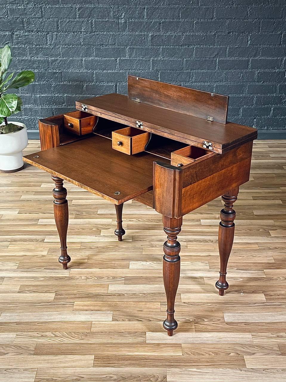 Condition: Original Vintage Condition

Materials: Walnut-Stained Mahogany
Style: Antique Victorian

This exquisite 1940s antique spinet-style writing desk blends elegance with clever functionality. Crafted from walnut-stained mahogany, it features