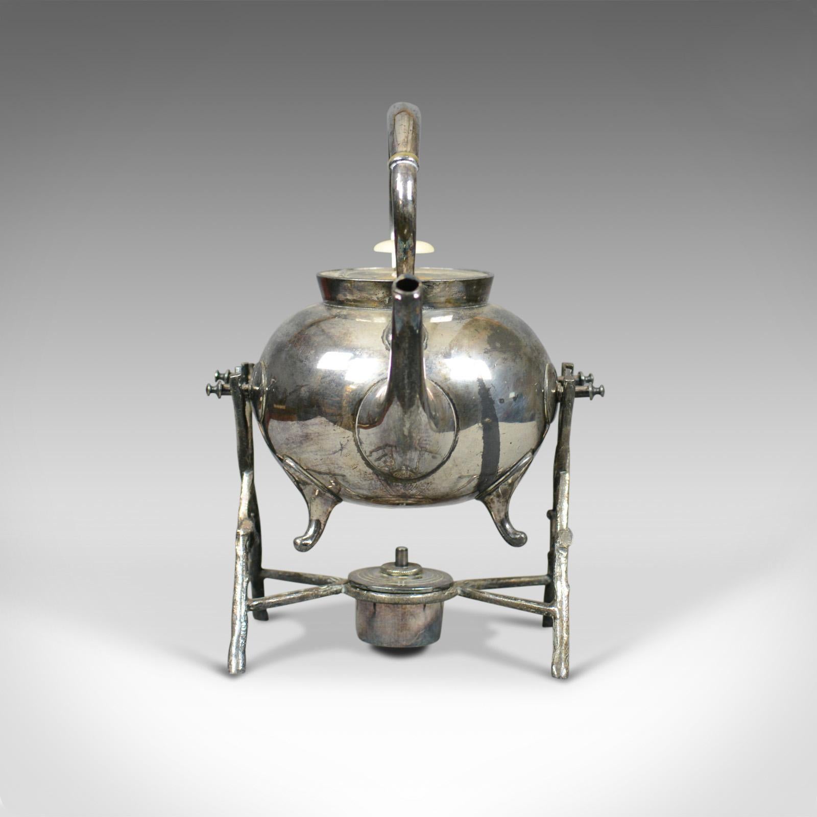 This is an antique spirit kettle on stand. A decorative silver plated tea pot on stand dating to the early 20th century.

An attractive spirit kettle on stand
Double fulcrum stand provides 'on stand' pouring
Beautifully crafted and