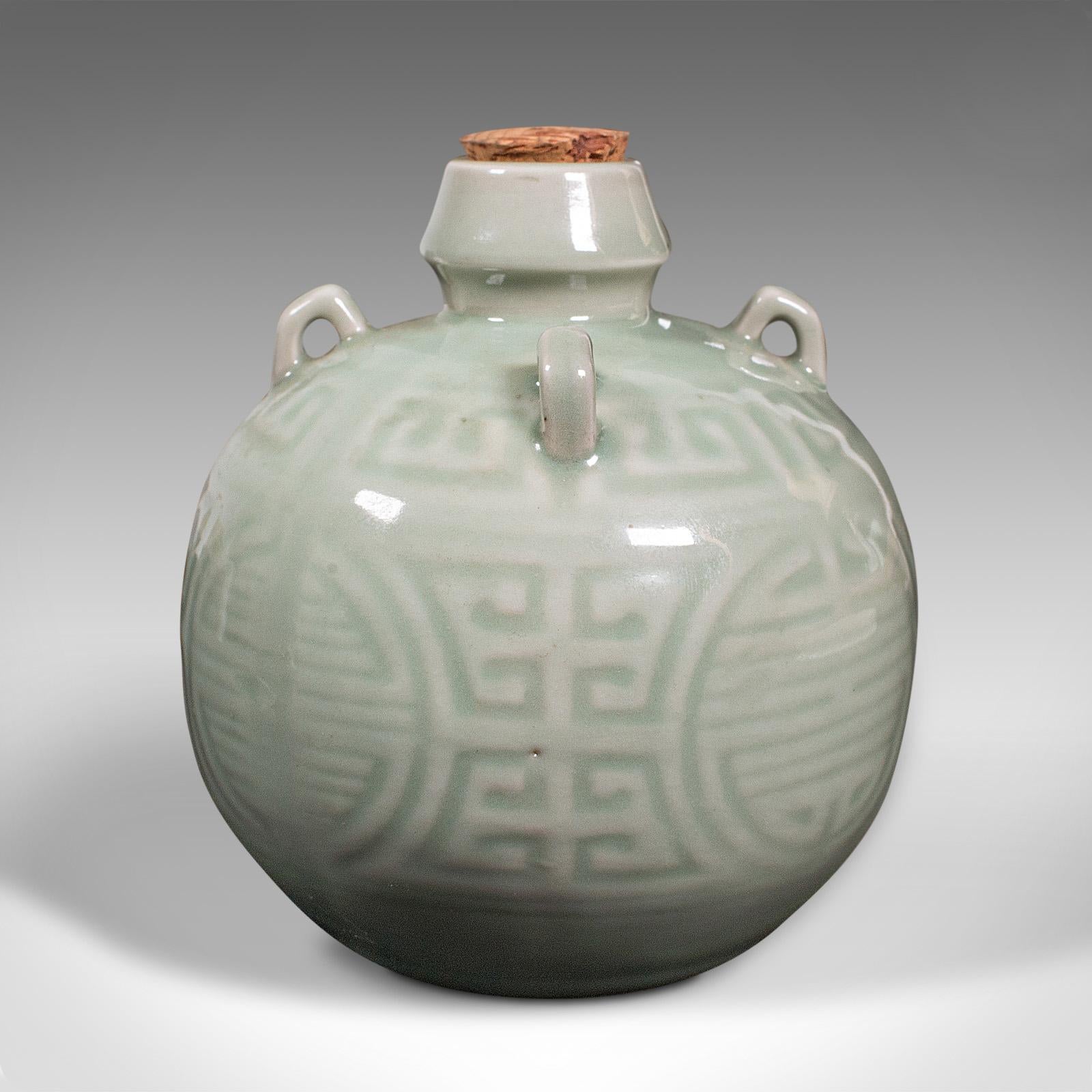 This is an antique spirit pot. A Chinese, celadon ceramic gourd, dating to the late Victorian period circa 1900.

Fascinating globular form with appealing light green hues
Displays a desirable aged patina and in very good order
Glazed celadon