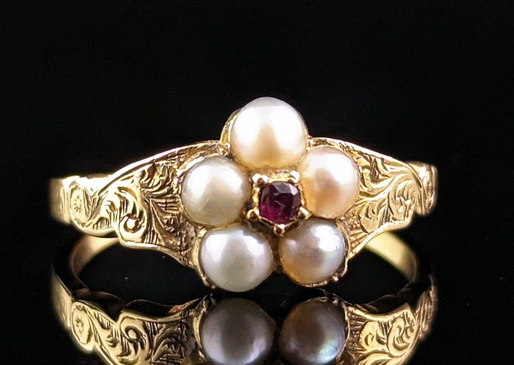 This dainty antique split pearl and Ruby floral cluster ring is delicately charming and oh so sweet.

We love it's soft floral design and lustrous creamy pearls with a single rose cut ruby set to the centre.

The ring is crafted in rich 18ct yellow