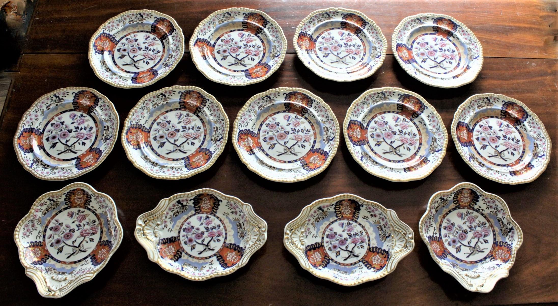 This antique set of plates and bowls was made by the Spode factory of England in approximately 1823 in a Chinese inspired style. The set consists of nine luncheon plates, two sweet meat dishes and two serving bowls. Each piece is decorated with