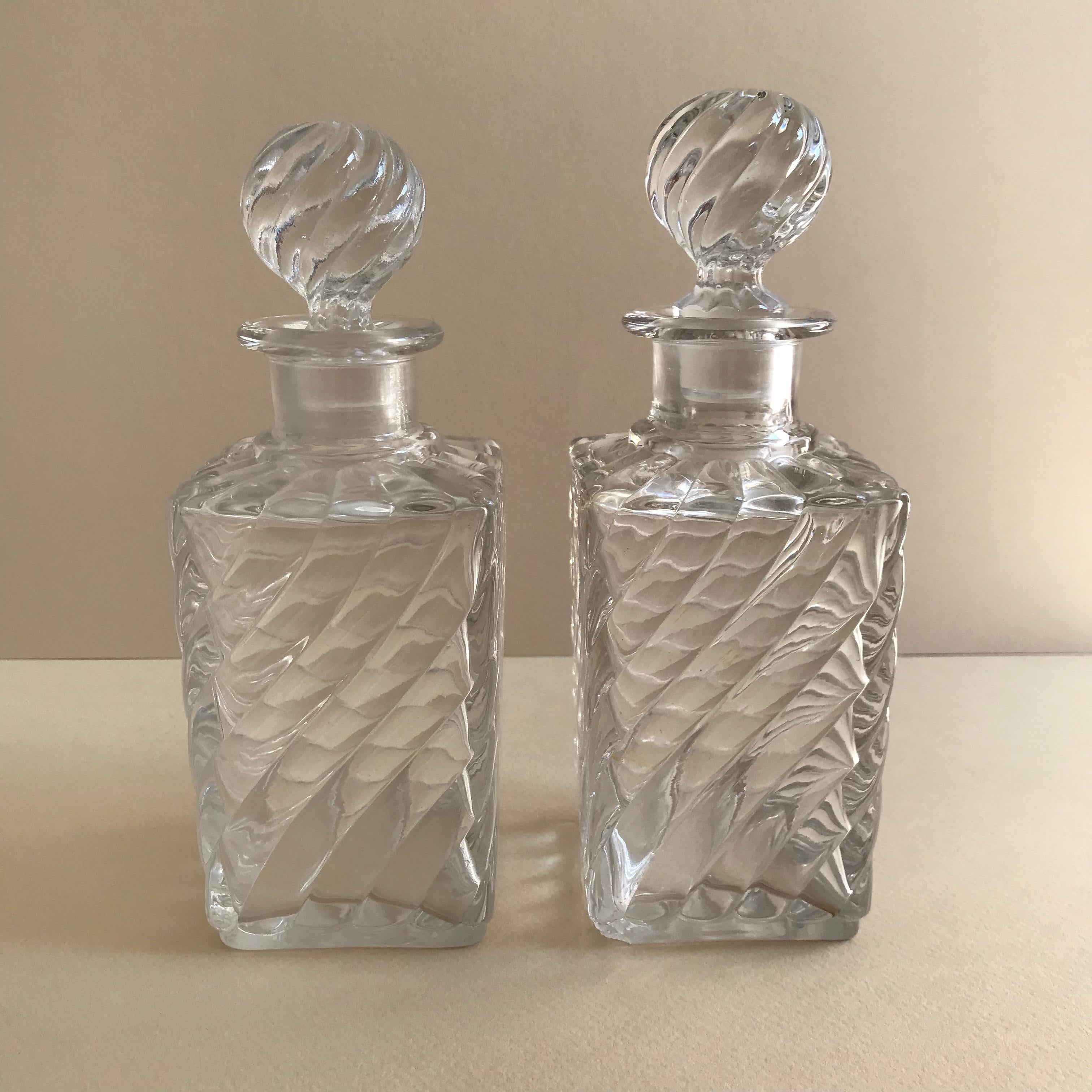 Pair of French antique square base crystal Baccarat perfume bottles in a swirled bamboo pattern.
Measures: Height 18.00 cm approximate 
Depth 6.50 cm
Width 6.50 cm.