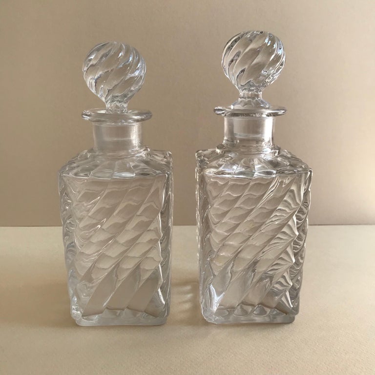 Pair of French antique square base crystal Baccarat perfume bottles in a swirled bamboo pattern.
Measures: Height 18.00 cm approximate 
Depth 6.50 cm
Width 6.50 cm.